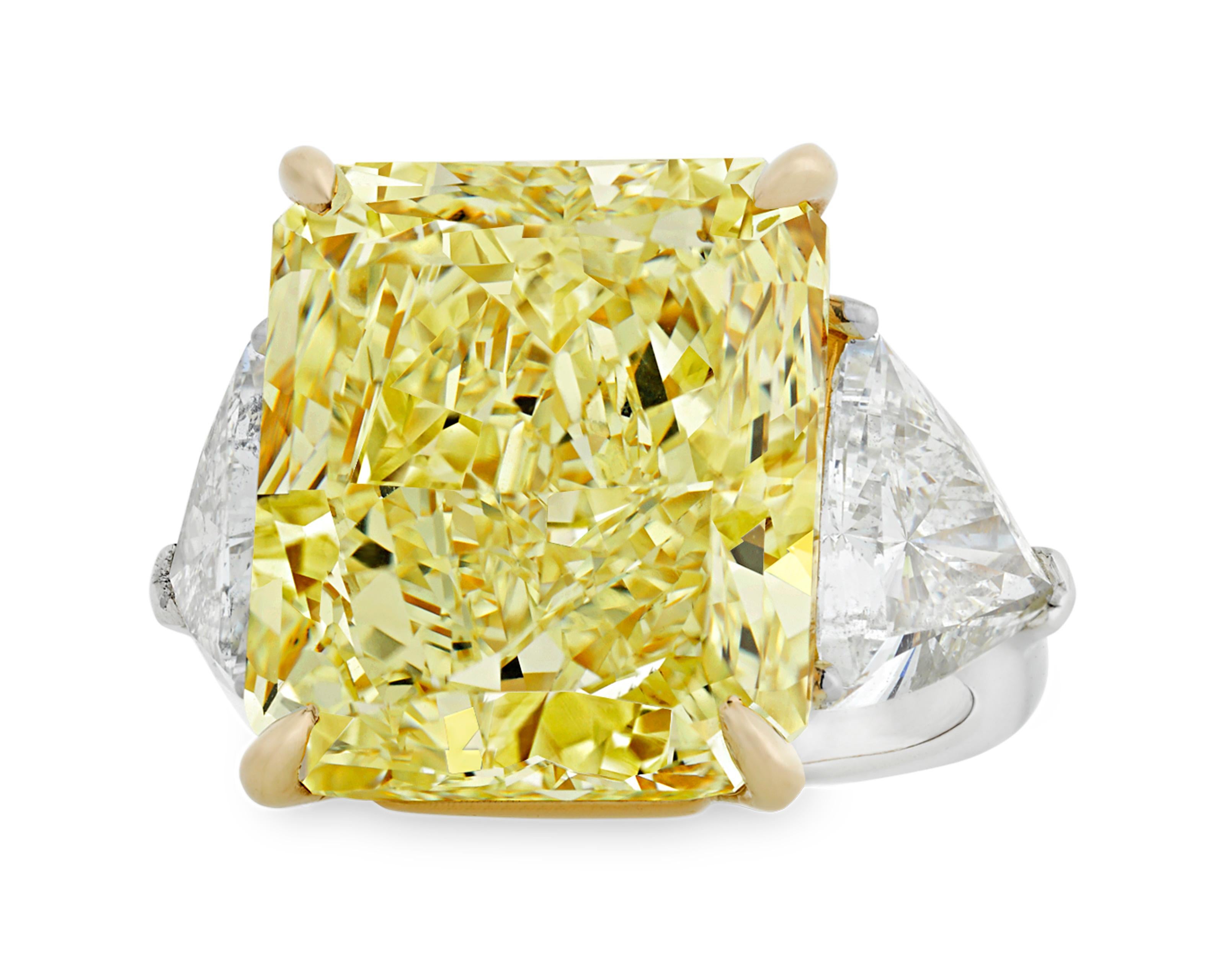 This monumental 20.28-carat natural fancy yellow diamond ranks among the rarest and most coveted of all gemstones. The rare stone is certified by the Gemological Institute of America (GIA) as natural fancy yellow, and its exceptional hue displays