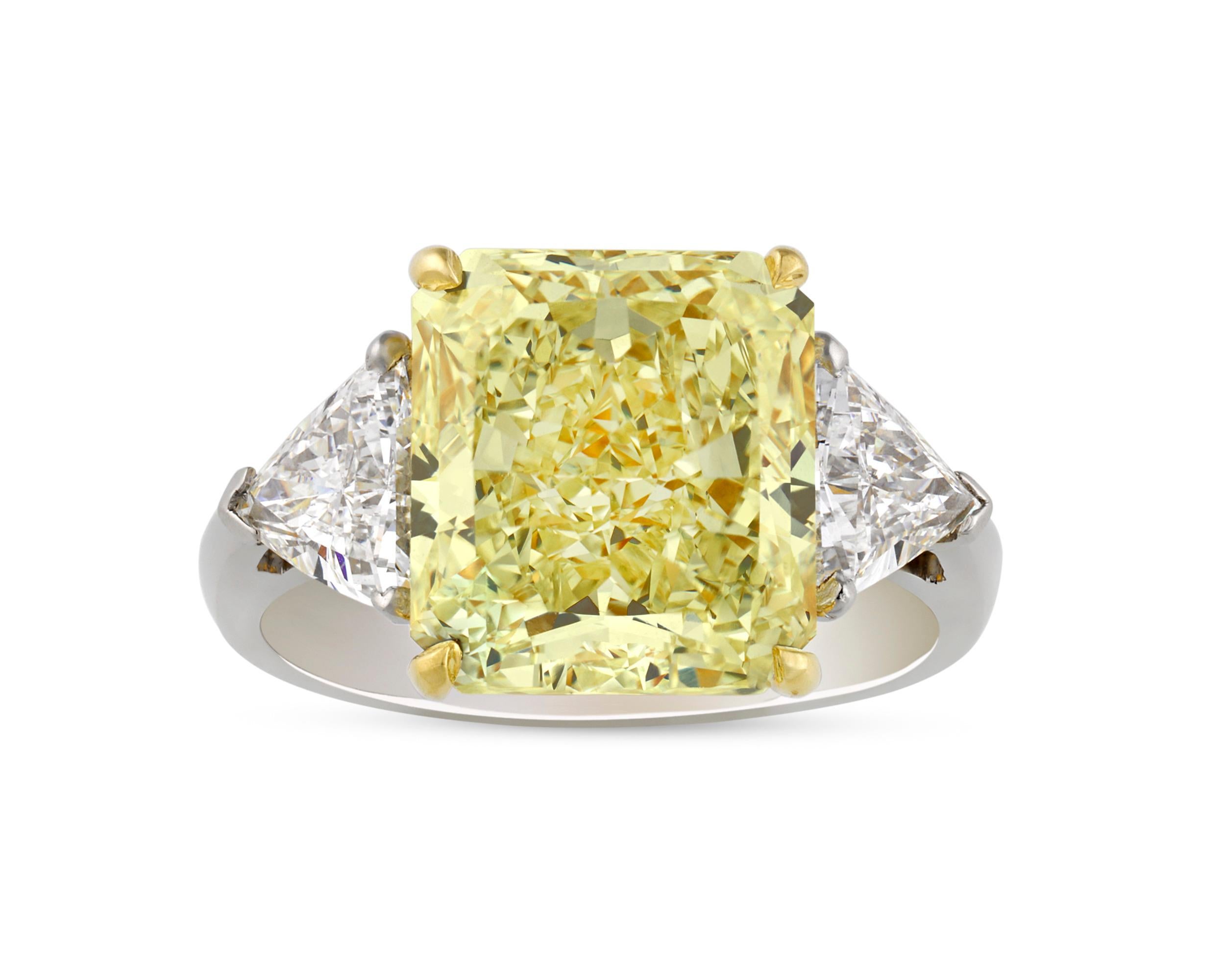 The spectacular, modified brilliant-cut natural fancy yellow diamond in this ring totals 6.42 carats. Yellow diamonds are among the most coveted gemstones in the world, and this is a truly exceptional example of their beauty. The diamond is