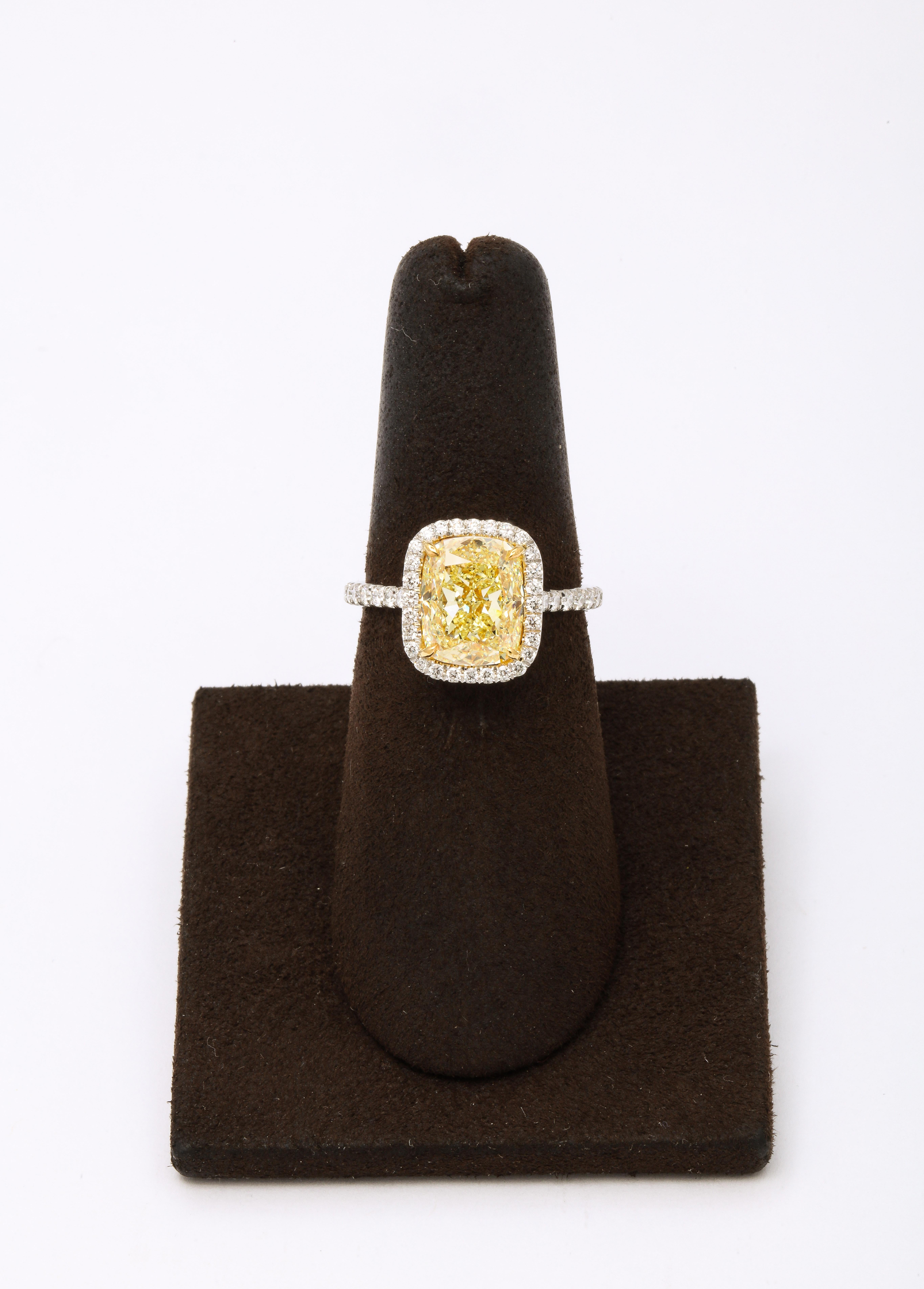 
A beautiful cushion cut! 

3.51 carat GIA Certified Fancy Yellow, VS1 center diamond. 

Set in a custom platinum mounting with .50 carats of colorless white round brilliant cut diamonds. 

A beautiful and vibrant center diamond with strong Fancy