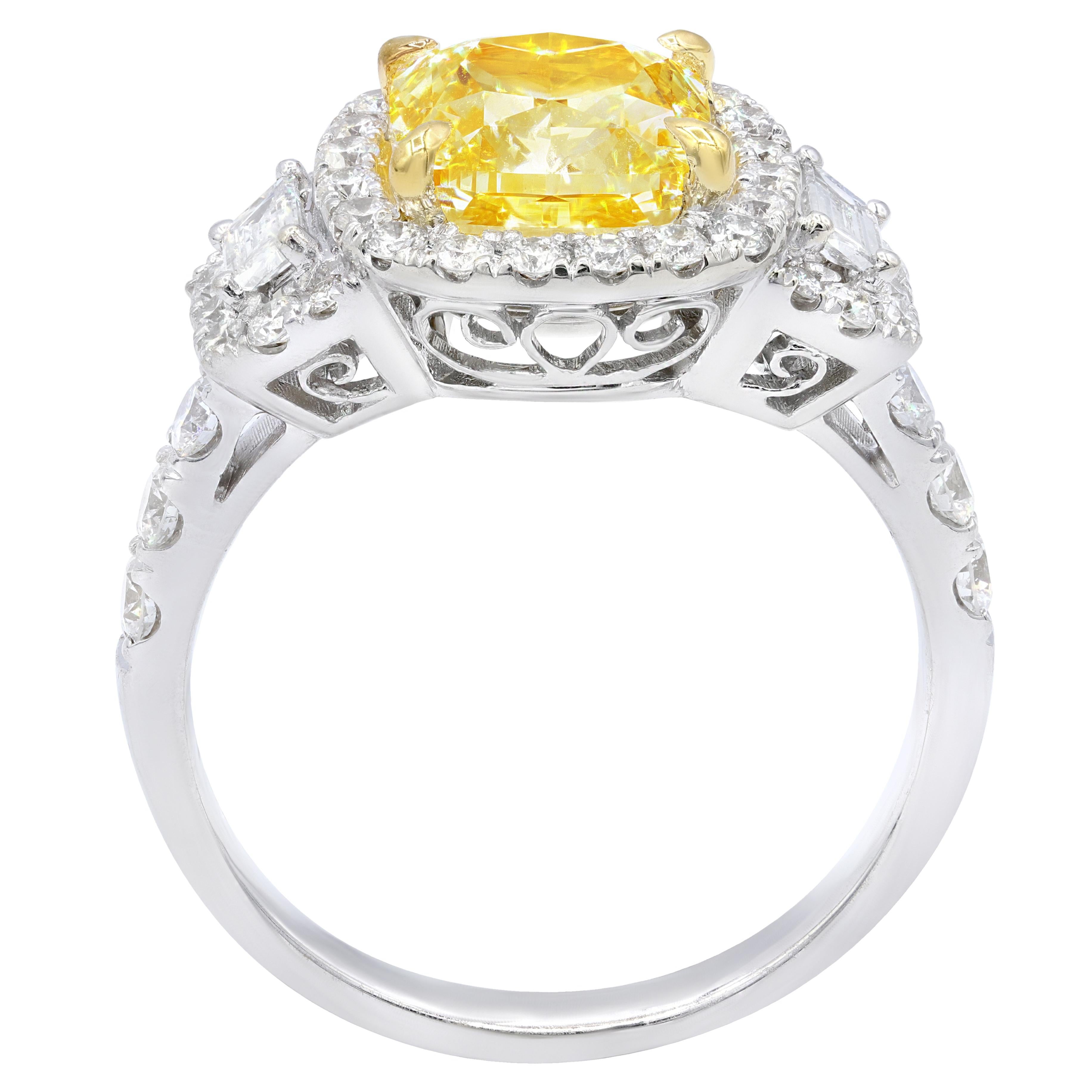 18K yellow gold fancy yellow diamond ring, features 2.39 ct fancy light yellow cushion cut diamond set in halo setting with two trapezoids 1.00 ct total weight of diamonds.