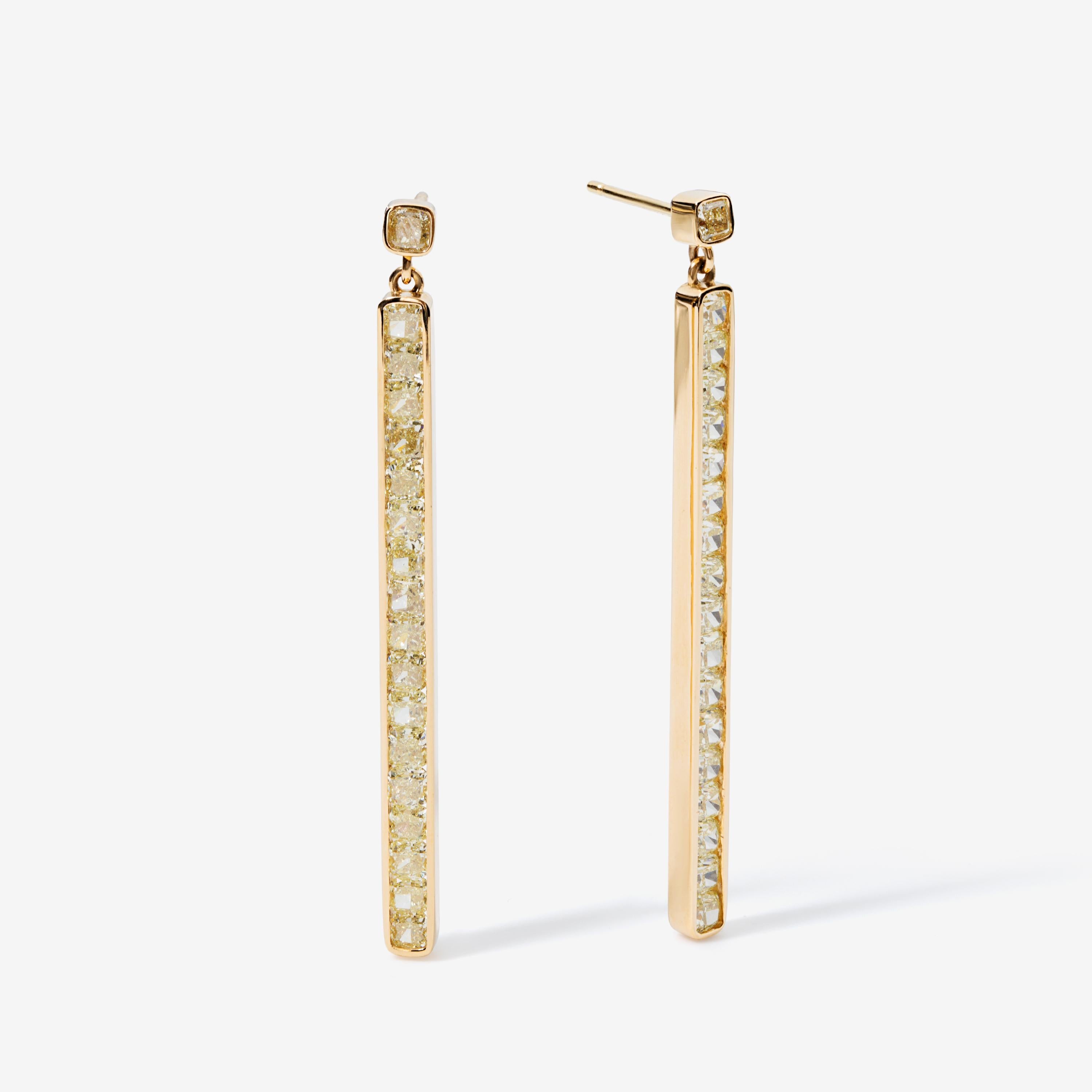 This pair of earrings is crafted from 3.85 carats of cushion-cut fancy yellow natural diamonds. The stones are channel-set in 18k yellow gold to emphasize their warm glow.

Versatile and sophisticated, these yellow diamonds are understated luxury at