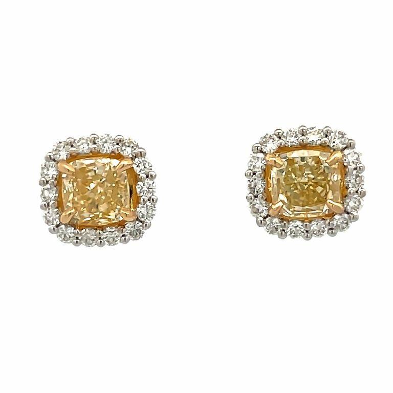 This pair of earrings are made of cushion fancy yellow diamonds with a total carat weight of 1.84 carats, selected for their clarity and brilliance. The yellow diamonds are set in a white gold setting 18-carat weight, accented with a single row of