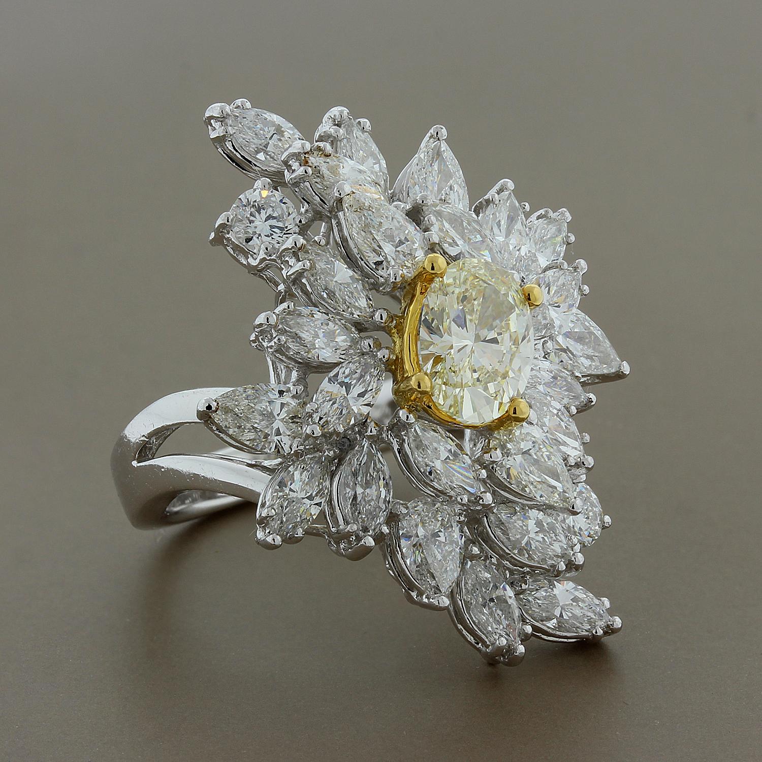 Wow them with this extraordinary ring featuring a 1.51 carat fancy yellow oval cut diamond in the center of a sparkling cluster of white diamonds. The cluster features 4.73 carats of white diamonds in pear, marquise and round cuts. Set in luxurious