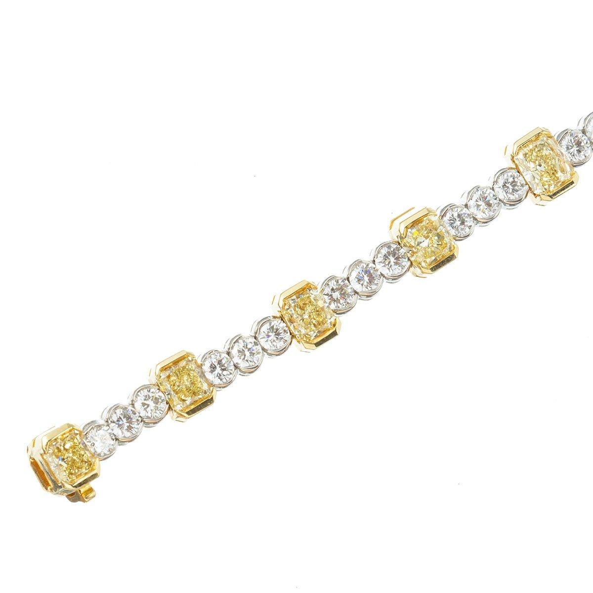 Bezel-set yellow and white diamond line bracelet, featuring larger radiant-cut natural fancy yellow diamonds each separated by three smaller near-colorless round brilliant-cut diamonds, in a polished platinum and 18k yellow gold setting. Eleven