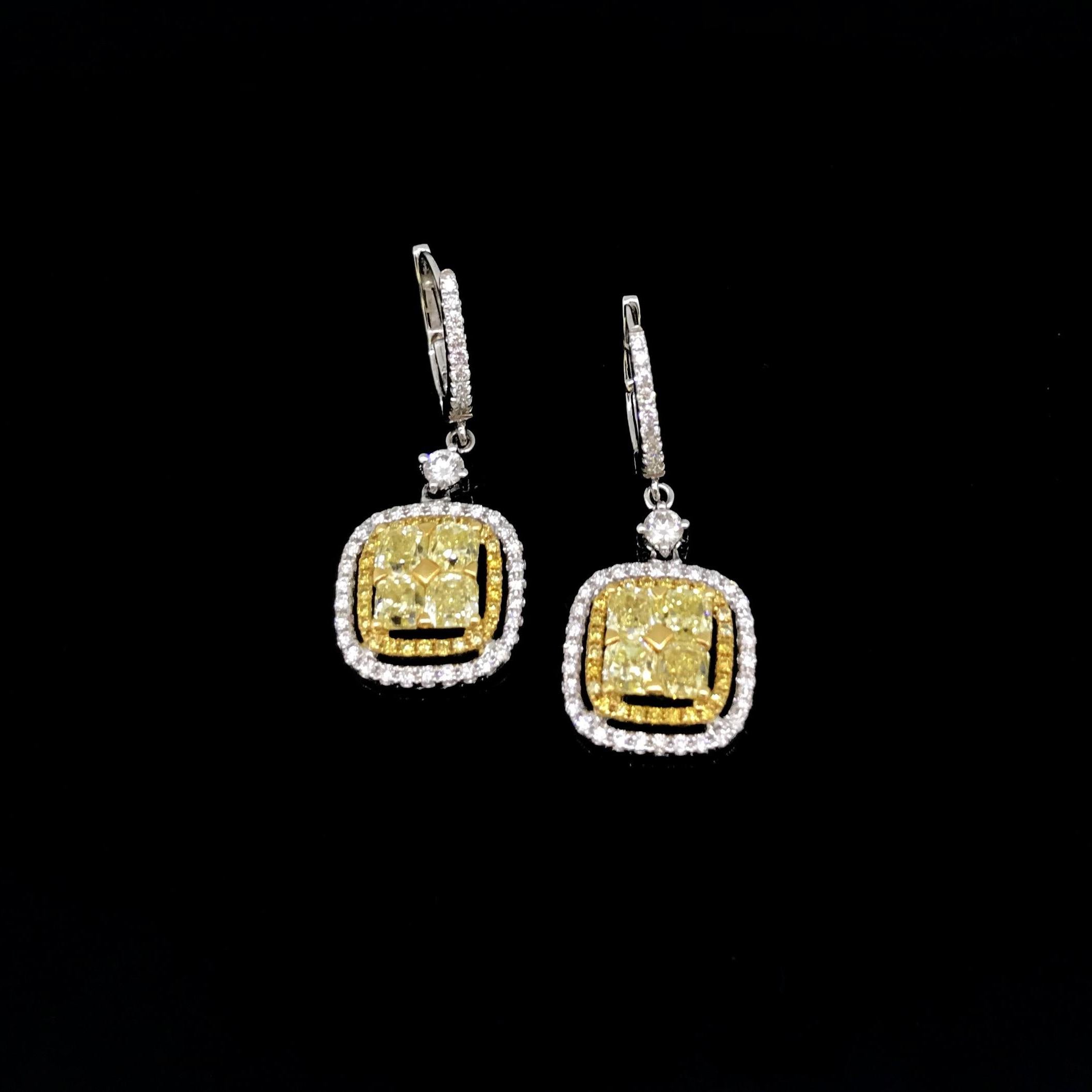 This beautiful pair of earrings is fully made in 18kt white gold. Each earring is set with 4 square cushion yellow diamonds. These are clustered with round brilliant cut fancy yellow diamonds and finally with a final surrounding of white diamonds.