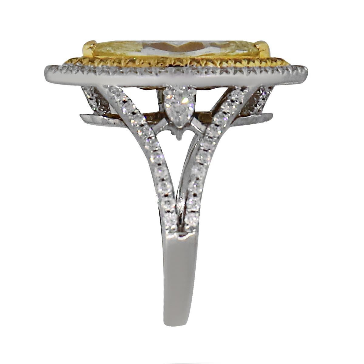 Material: 18k White Gold and 18k Yellow Gold
Center Diamond Details: Approximately 2.01ct Fancy yellow marquise cut diamond. 
Accent Diamond Details: Approximately 0.76ctw white round brilliant and yellow enhanced diamonds. Diamonds are G/H in color