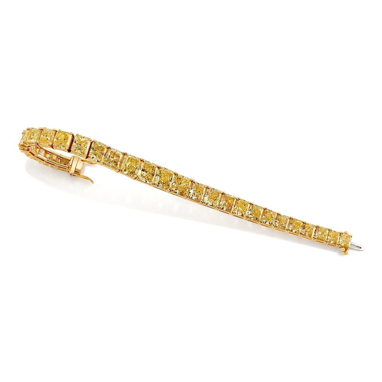 18K Yellow Gold 

GIA 45.05ctw (29) Fancy Yellow-Fancy Intense Yellow VS1-SI Radiant Cut Diamond Line Bracelet

Originally featured on the cover of the 1995 Neiman Marcus Holiday Book
Includes GIA Certificate and a photo copy of the 1995 Neiman