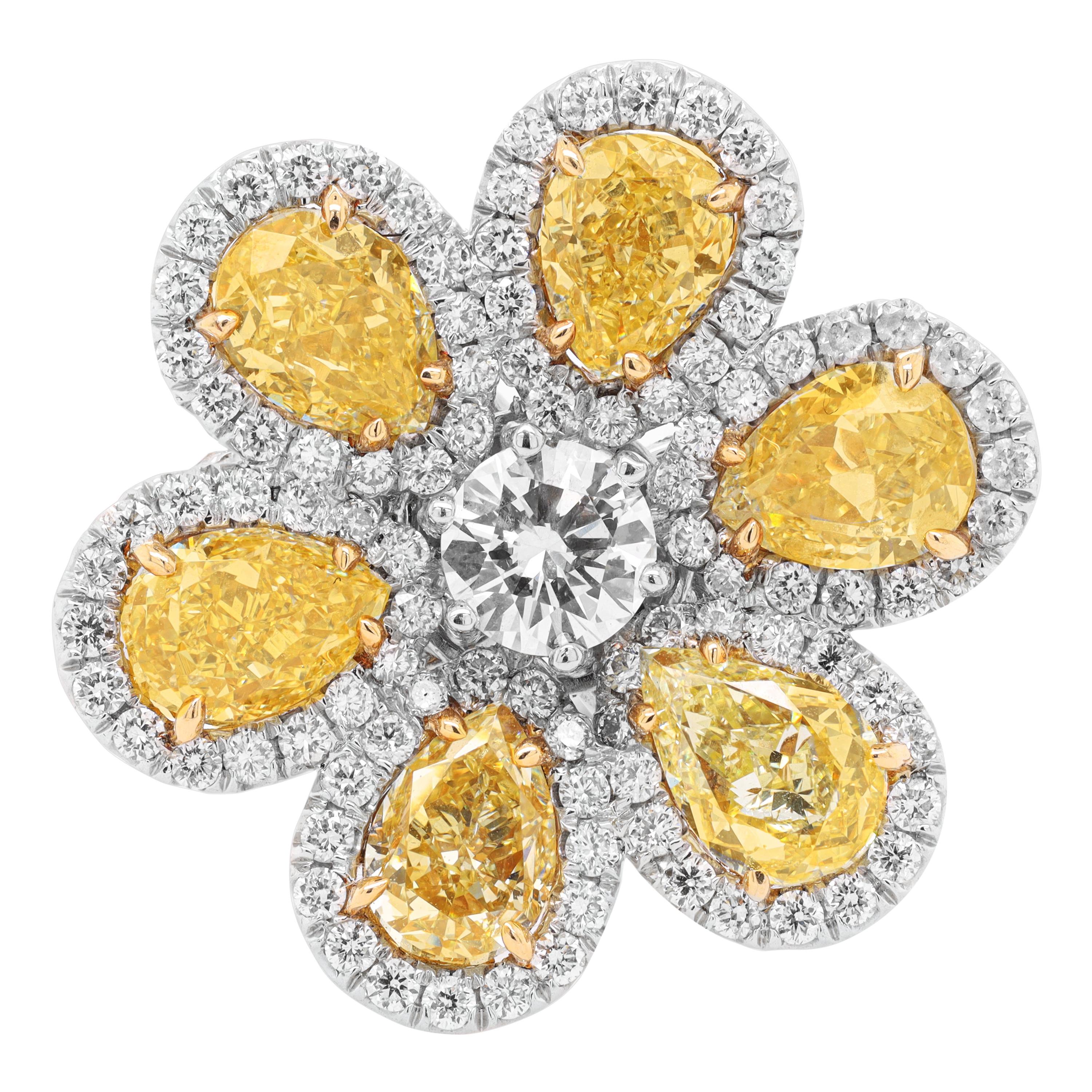 Fancy yellow flower diamond ring with five gia certified fancy yellow pear shape diamonds and and one gia certified white round diamond in the middle with micropave round diamonds around in plat and 18kt yellow gold.
