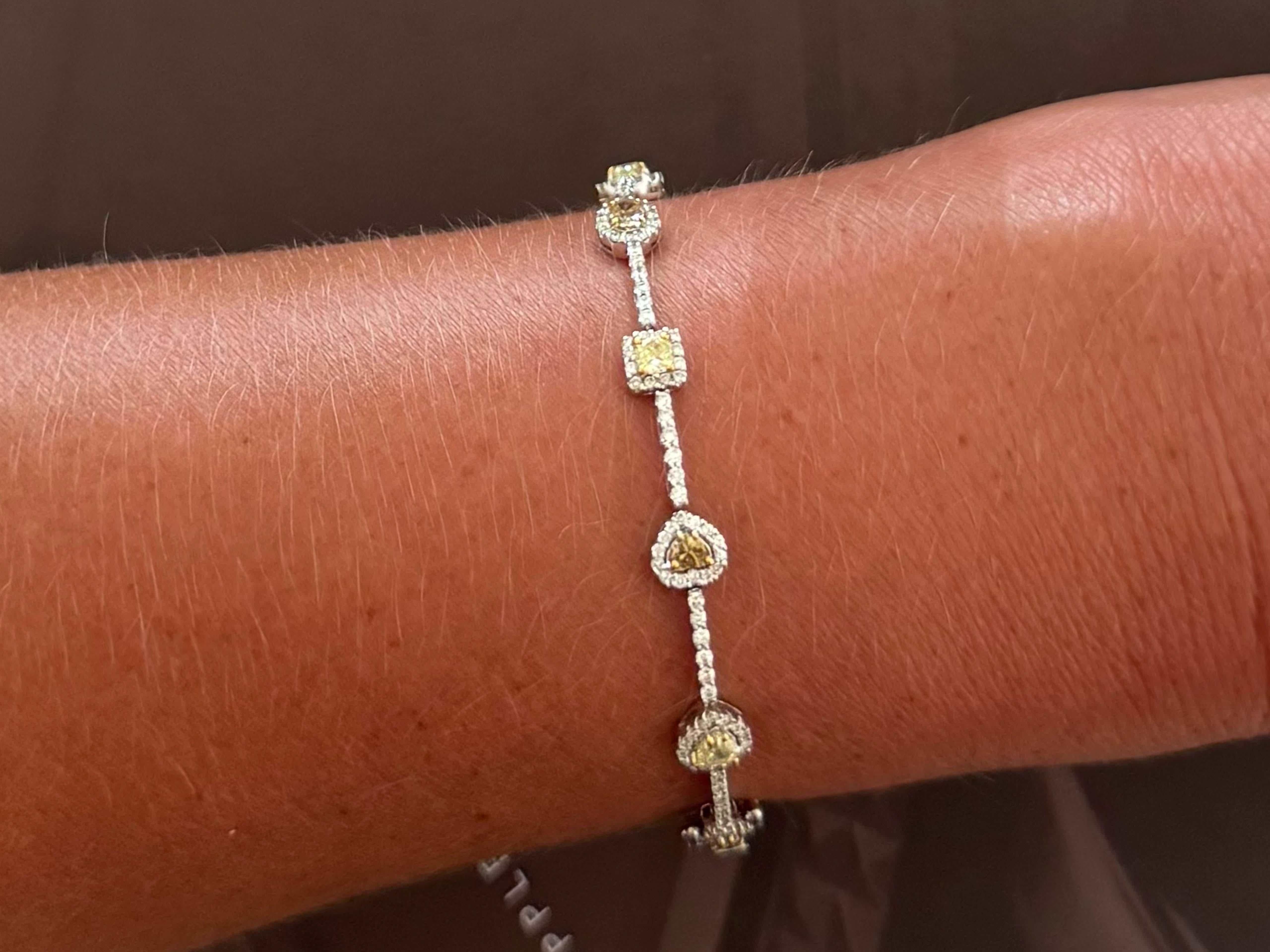 Bracelet Specifications:

Metal: 18k White Gold

White Diamond Count: 230 brilliant cut diamonds

White Diamond Carat Weight: 1.33

White Diamond Color: G-H

White Diamond Clarity: VS
​
​Colored Diamond Count: 12 (5 fancy yellow and 7