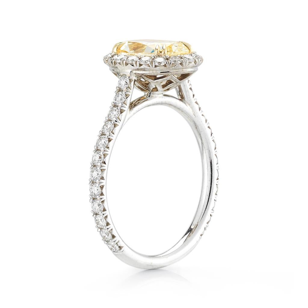 This diamond ring features fancy yellow oval cut center stone in a halo setting and a pave band. 

Made in platinum and yellow gold this ring is absolutely stunning and like no other will get lots of compliments. Very rare and special this fancy
