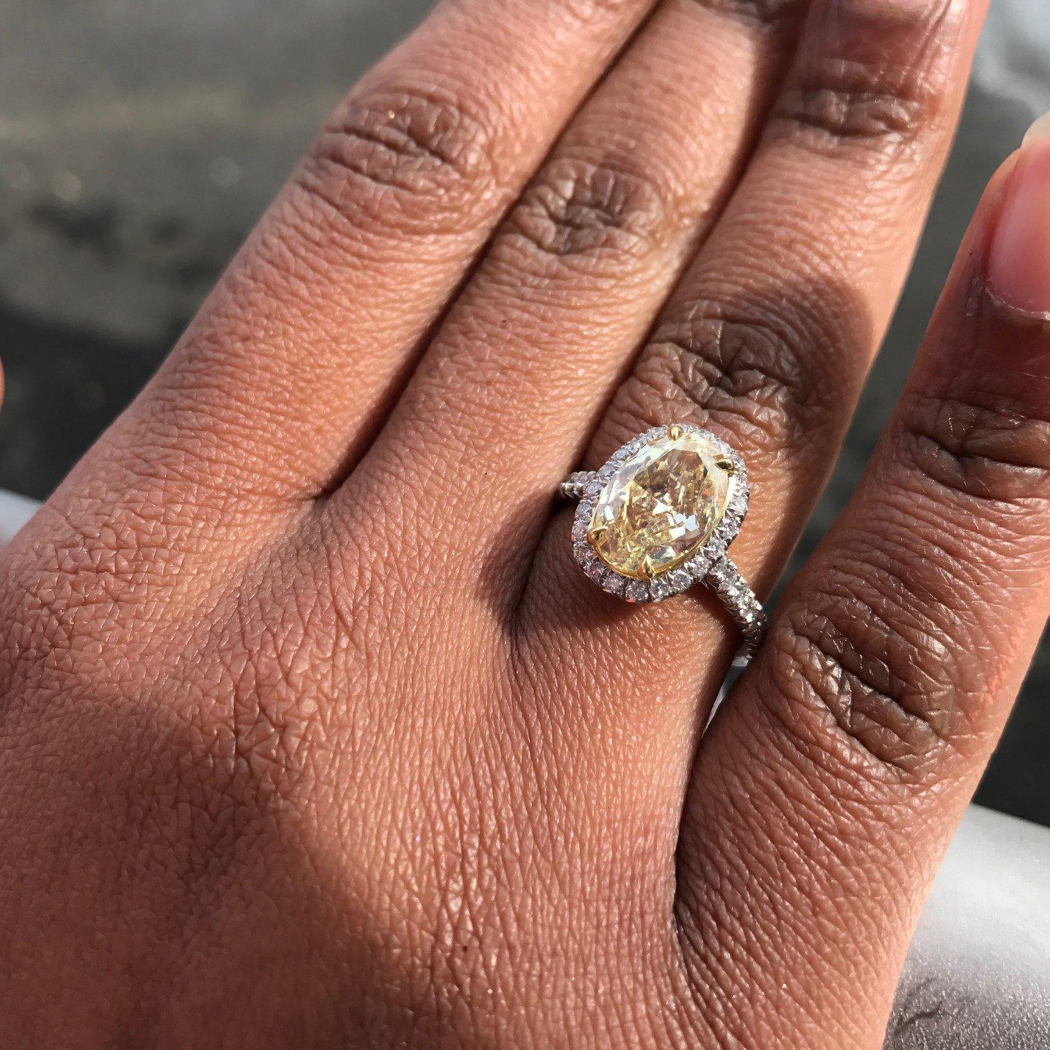 Modern Fancy Yellow Oval Cut Halo Set Diamond Engagement Ring in Platinum 2.38 Carat