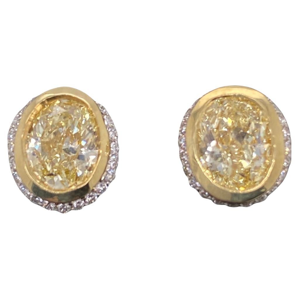 Fancy Yellow Oval Diamond 2.25 tcw Earrings Bezel Set in 18kt Yellow Gold Plat For Sale