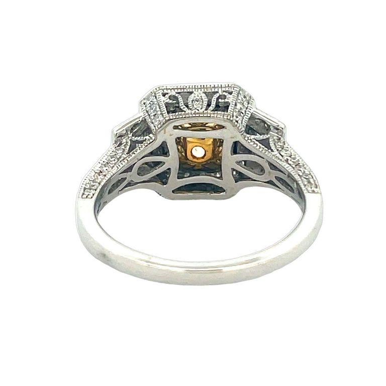 Get ready to be blown away by the breathtaking beauty of this three-stone ring! Featuring a stunning princess-shaped fancy yellow diamond, this ring boasts a center stone weighing an impressive 1.30 carats. Accompanying the yellow diamond are two