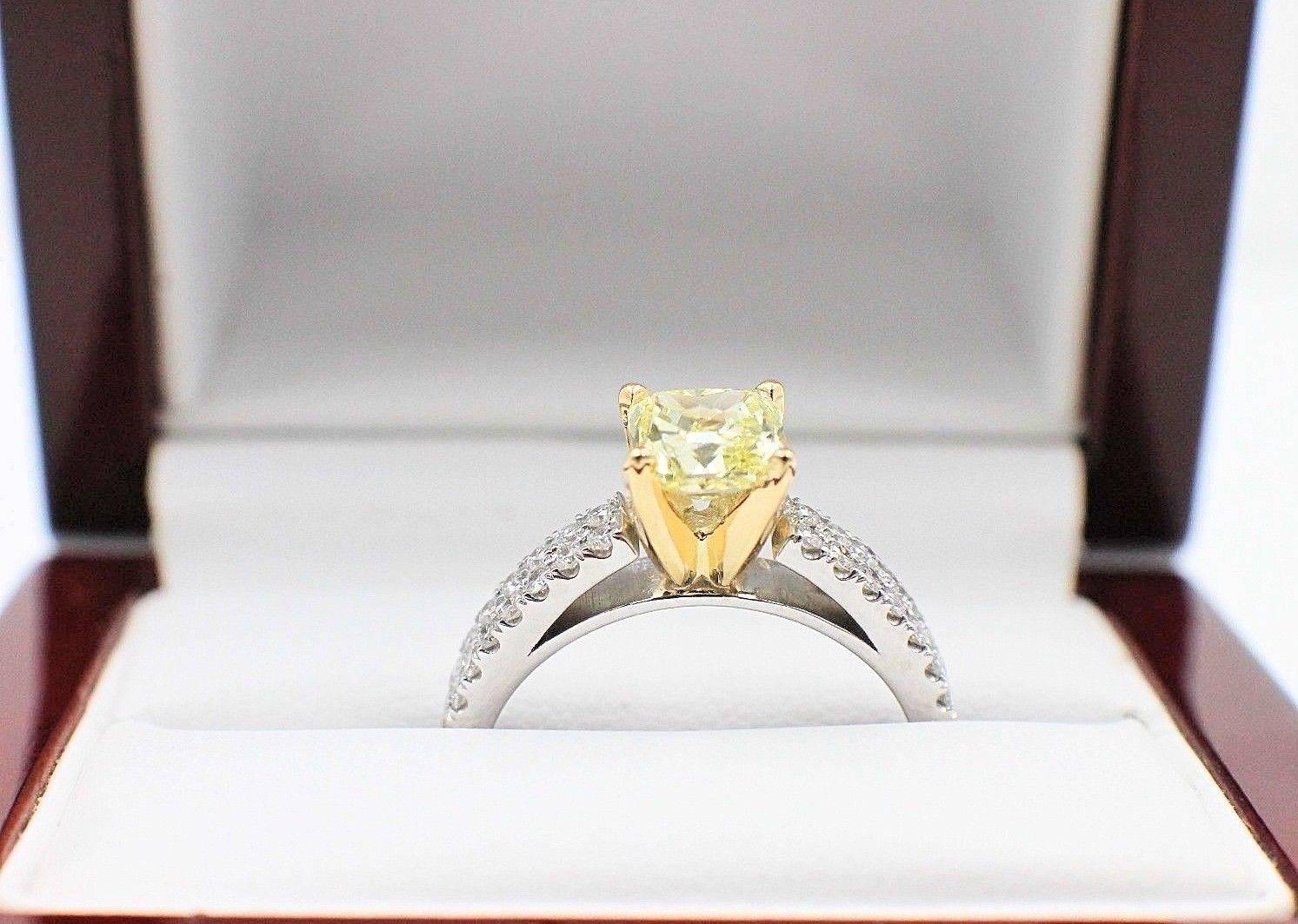 Fancy Yellow Diamond Engagement Ring with Diamond Band
Cetification:  GIA #2151128830
Metal:  18KT White & Yellow Gold
Size:  7.25 - Sizable
Total Carat Weight:  1.62 TCW
Main Diamond:  Radiant Diamond 1.20 CTS
Color & Clarity:  Fancy Yellow -