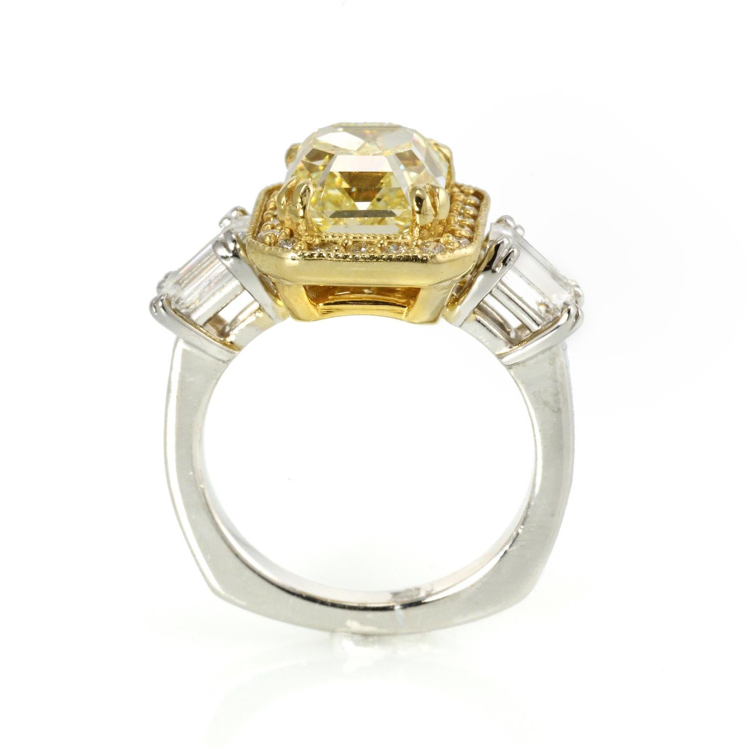 This Natural Fancy Yellow (VS1) is set in an interesting mounting. Purchased from an estate it is set with side Emerald Cut diamonds and a Halo of small colorless round diamond surrounding the center Fancy Yellow. 

Center Diamond: 3.00 Carat Fancy