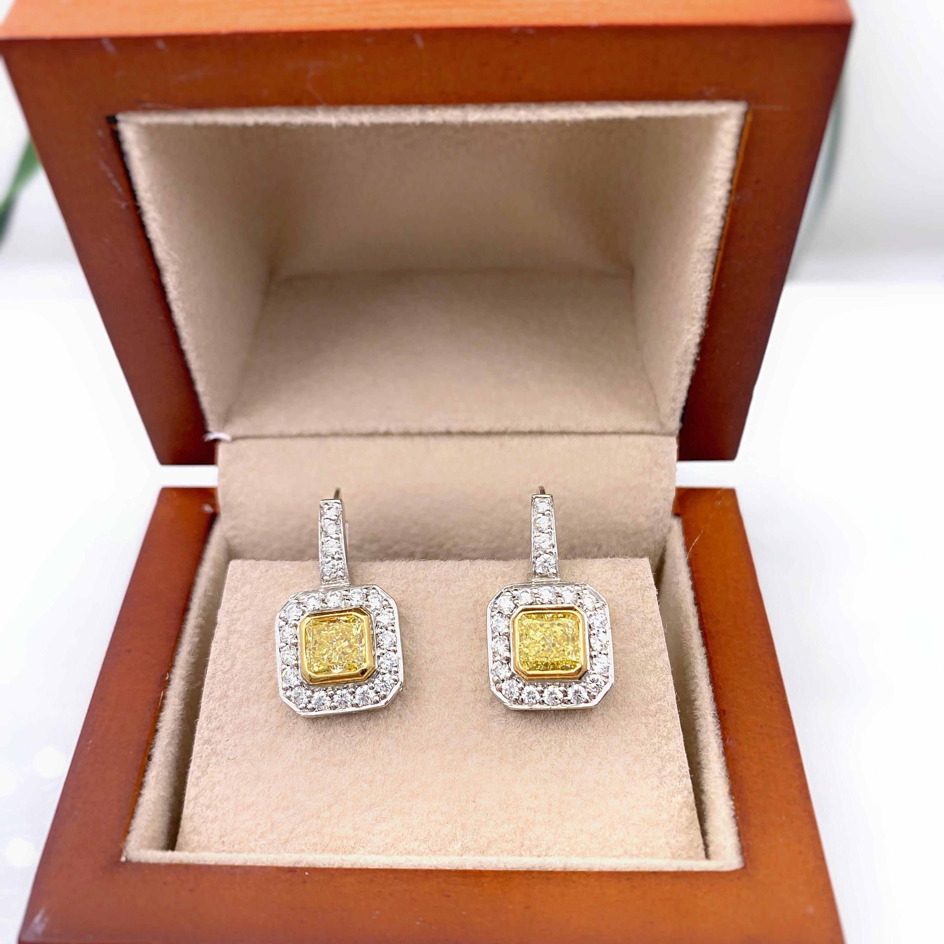 Fancy Yellow Diamond Earrings
Style:  Dangle
Metal:  14 kt White & Yellow Gold
Size:  19 MM Length = 10 MM Width
TCW:  2.20 tcw
Main Diamond:  Radiant Diamonds 1.40 tcw 
Color & Clarity:  Fancy Yellow - VS1
Accent Diamonds:  40 Round Brilliant