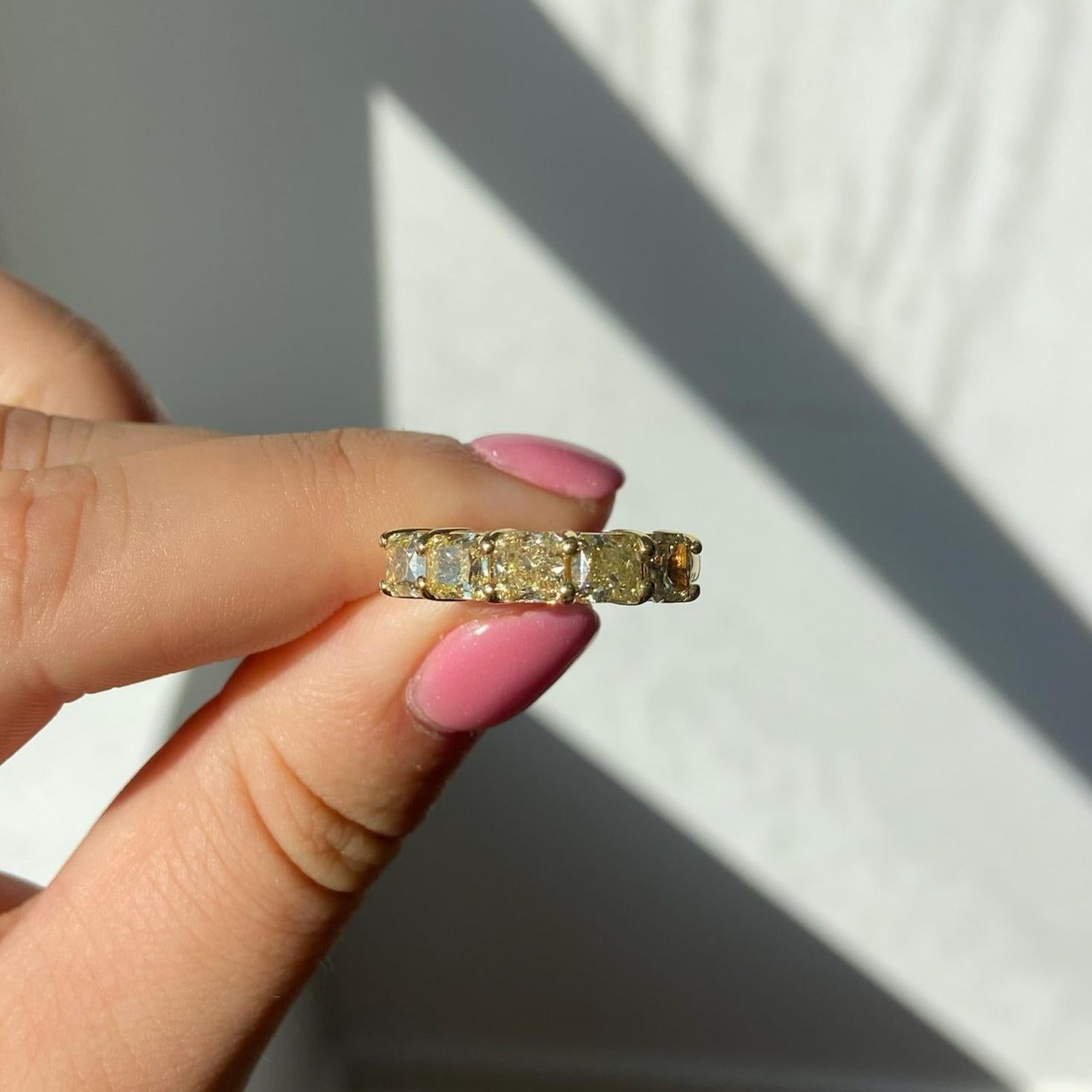 Signature half eternity band style, giving you the look of a full eternity band while using half the amount of diamonds. 
3.45 Carat Total Weight
5 Radiant cut diamonds
Fancy Yellow Color
VS-VVS Clarity Diamond
Set in 18k Yellow Gold
Handmade in