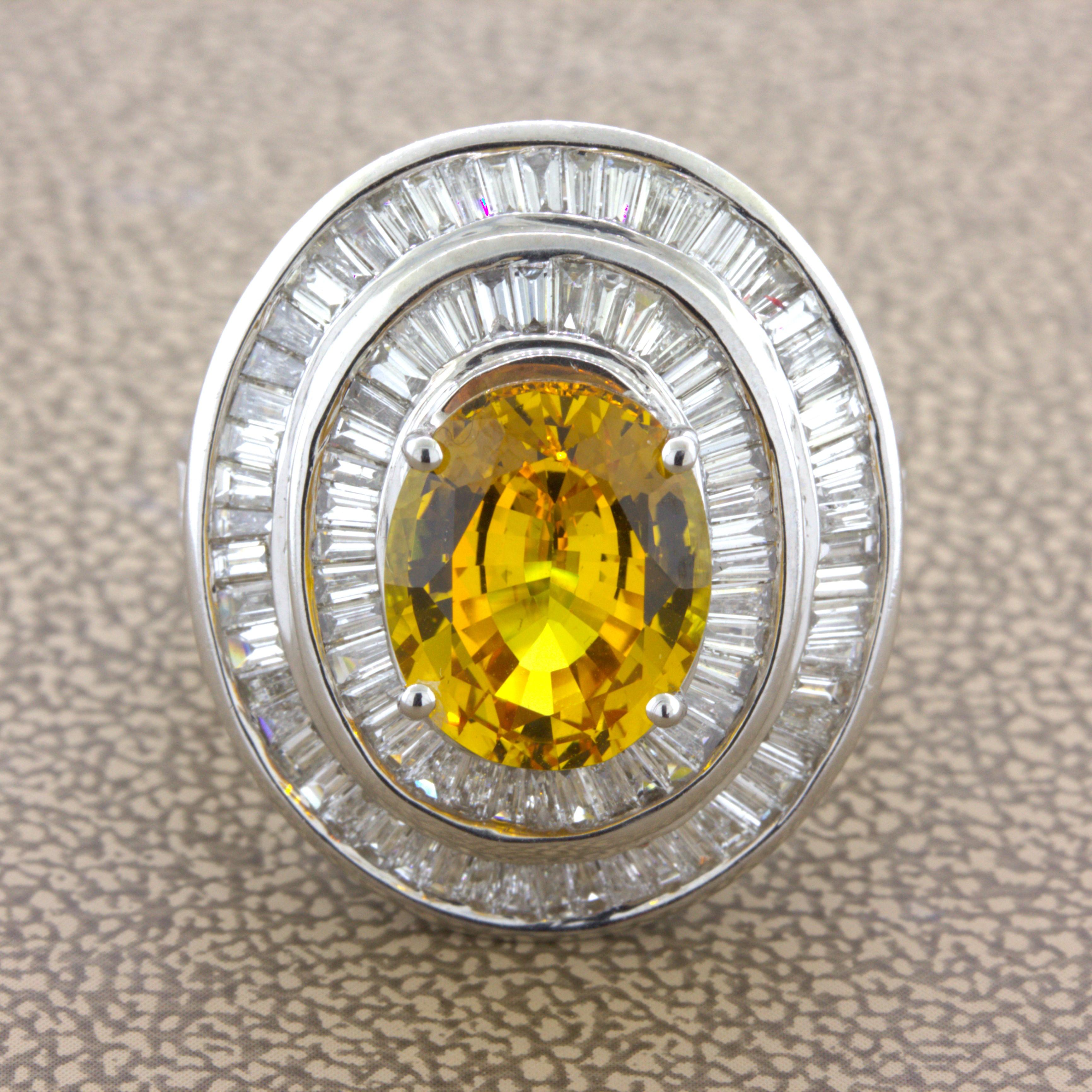 A vibrant and glowing fancy yellow sapphire takes center stage! It weighs 4.64 carats and has an intense bright yellow color that shines in the light. It is complemented by 2.28 carats of baguette-cut diamonds set around the sapphire in a double
