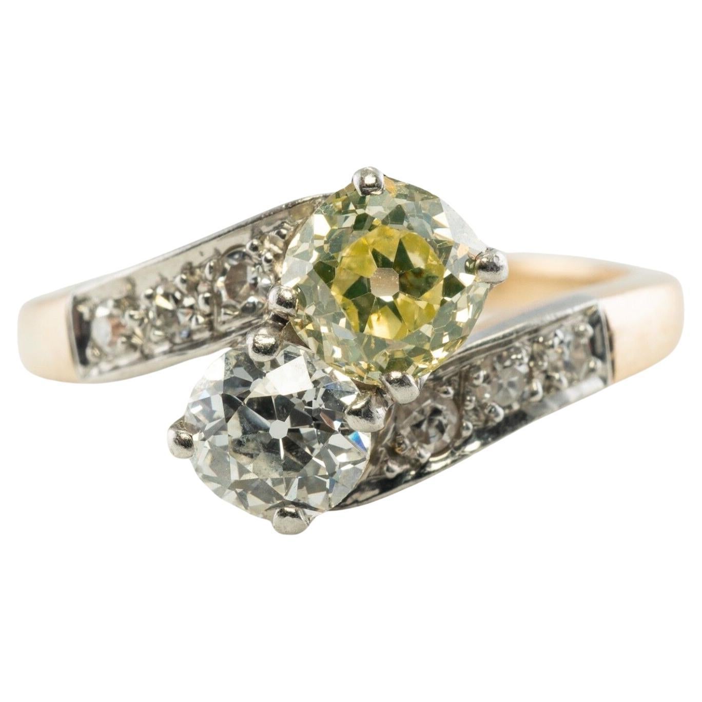 Fancy Yellow & White Diamond Ring 14K Gold Platinum 1.28 TDW Old Mine

This gorgeous Fancy Yellow Diamond & White Diamond Ring circa the 1910s is a finely crafted solid 14K Yellow Gold ring and Platinum ring. 
Two old mine-cut diamonds are set in