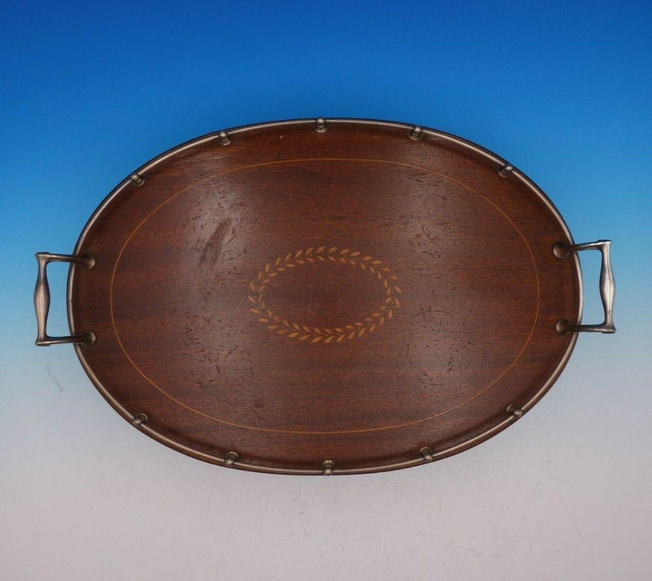 Faneuil by Tiffany & Co.

Superb Faneuil by Tiffany & Co. sterling silver and wood gallery tray marked #17931-6226. This tray features inlaid wood with a wreath cartouche. It has a date mark for 1907-1947.

The tray measures 18