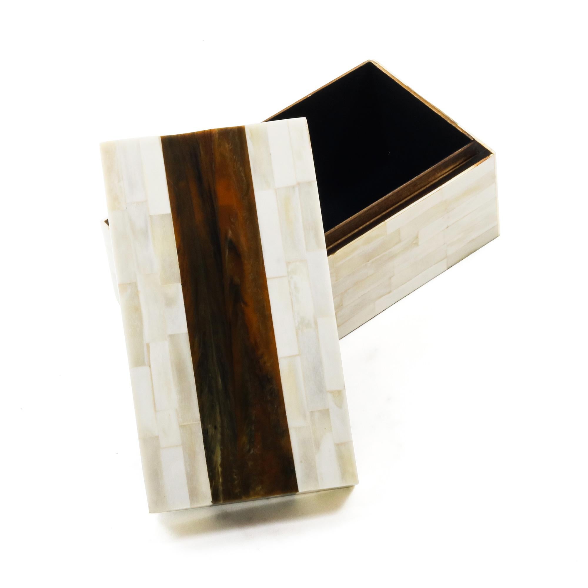 An ivory and brown decorative bone box featuring a contrasting stripe across the center and top.