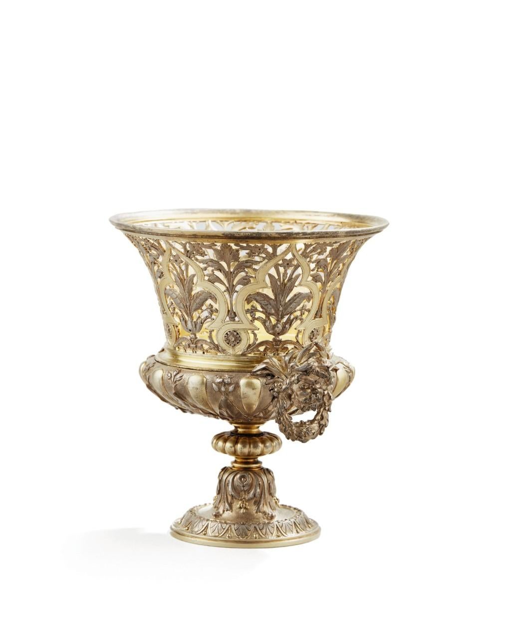 Fanniere Freres, a French two color gilt bronze vase, Paris, 1860

Exceptional quality orientalist style pierced bronze vase, molded with palms throughout the border. The body decorated with flowers and foliage scroll, with two river-God