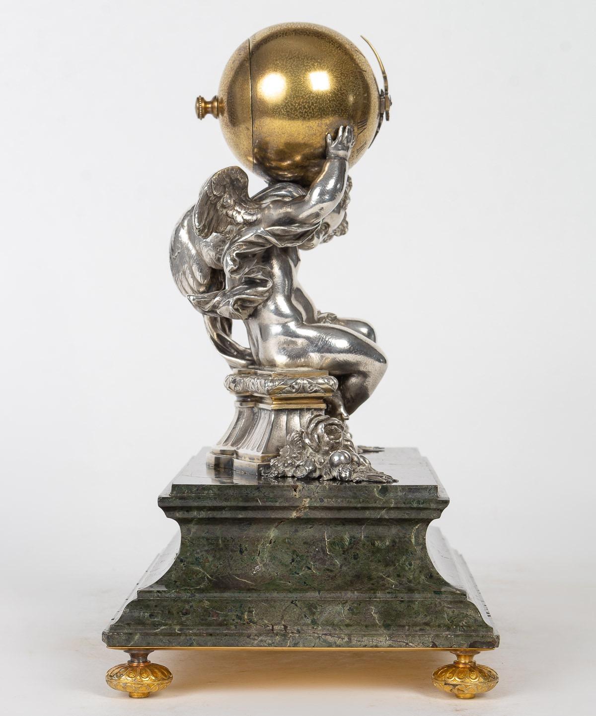 Fannières Frères Desk Clock Time Allegory

Chased gilt and silvered bronze Desk Clock 
With an allegorical theme of Time in the form of a cherub supporting a globe enclosing the movement and indicating the hours engraved in Roman numerals.
he is
