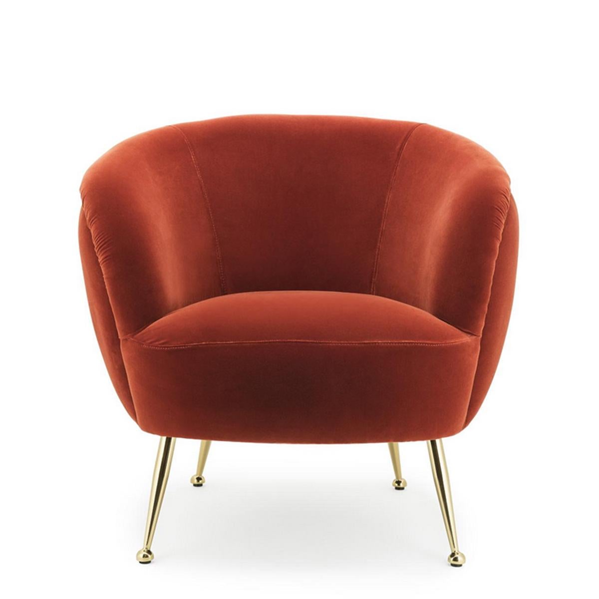 Armchair Fanny Coral with solid wood structure,
upholstered and coverd with velvet fabric in coral orange
color. With polished brass feet.