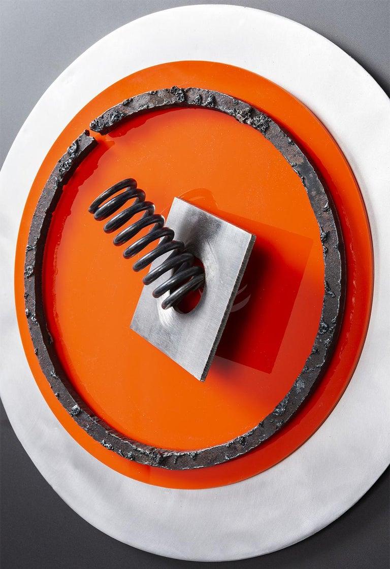 Assembler Naranja N°3. Wall sculpture
Acrylics, aluminum, screws, and painted metal ring on aluminum
Dimensions:  40 H x 40 W x 8 D cm.
2021

______
Fanny Finkelman's sculptures are the result of a continuing exploration of the many materials that