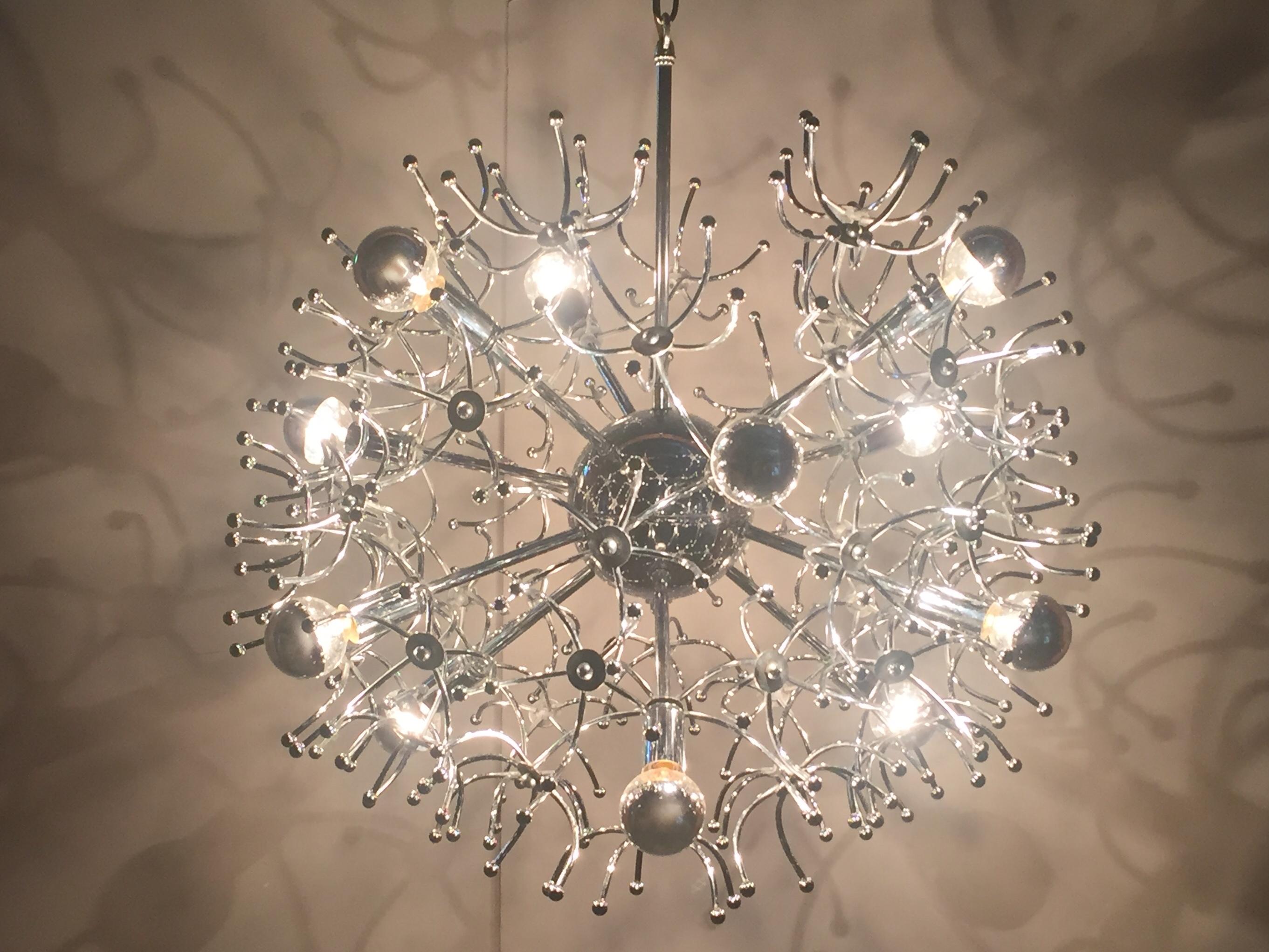 A round multi arm 12 bulb glistening chrome Sputnik chandelier with dozens of decorative tendrils that make this vintage fixture look like an amazing underwater creature.
Bottom of fixture to top of chrome rod is 25 inches, extra chain is included