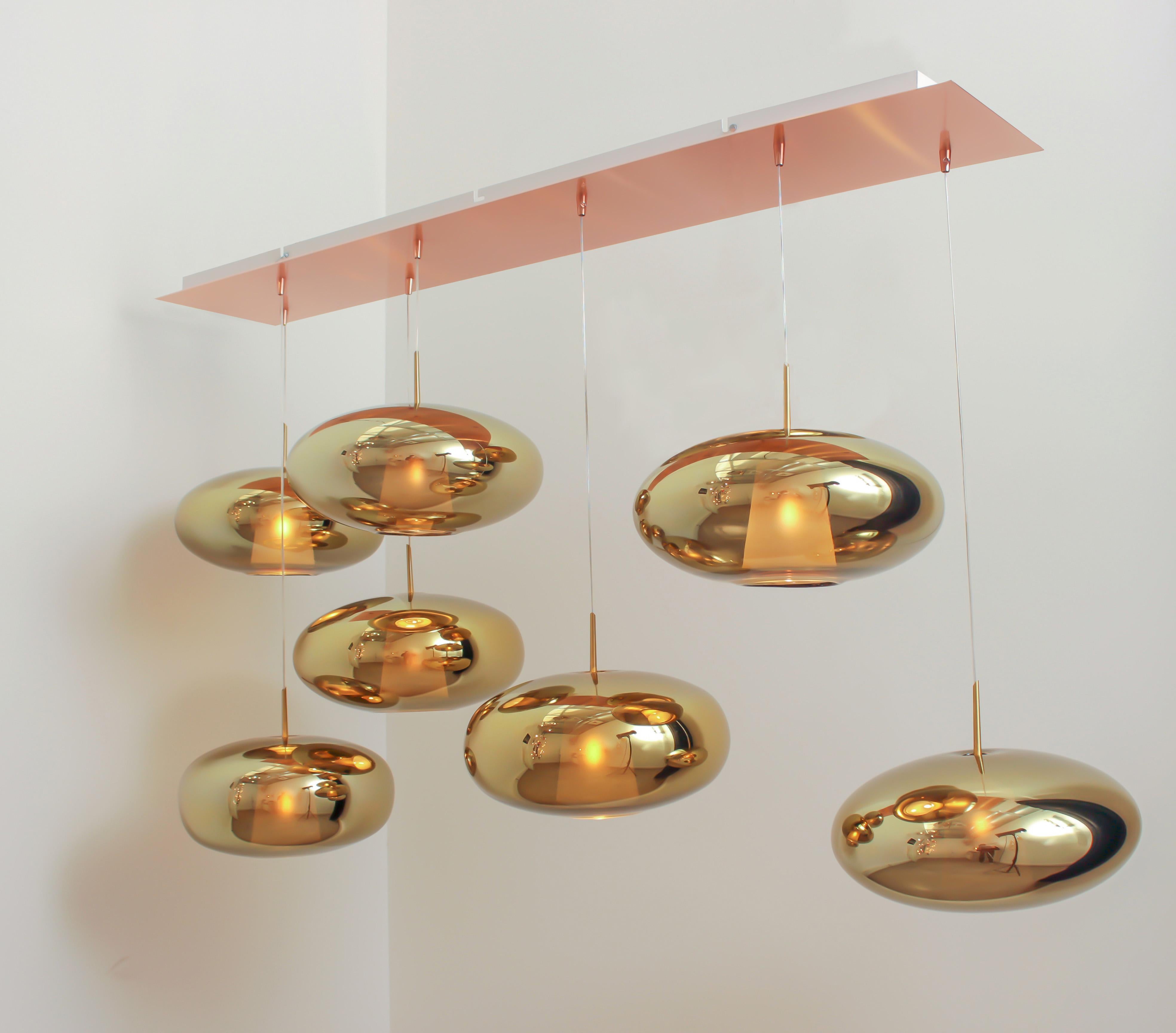 Hand blown glass pendants. 7 glass lights on 140 cm x 55 cm rectangular canopy.

Glass dimensions: ? 38 cm x H 17 cm. 

The Fantasia Extra glass and its saucer shape allows to play on the horizontality, where most of the suspensions bet on their