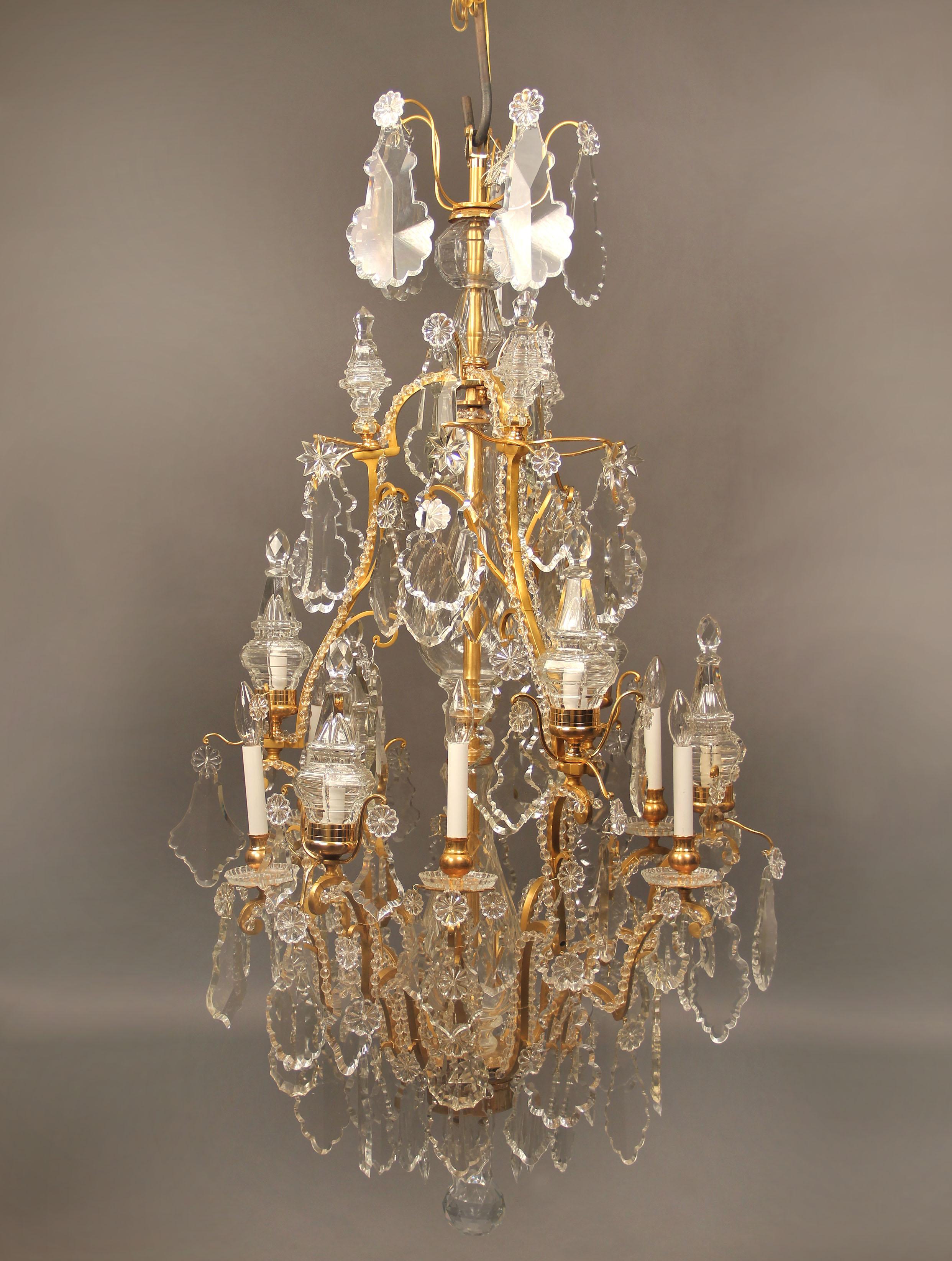 A Fantastic late 19th century Gilt Bronze and Baccarat Crystal Twelve Light Chandelier

Multi-faceted and shaped crystal, beaded arms, cut crystal central column, 6 lit spears as part of the twelve perimeter lights, bobeche cups.