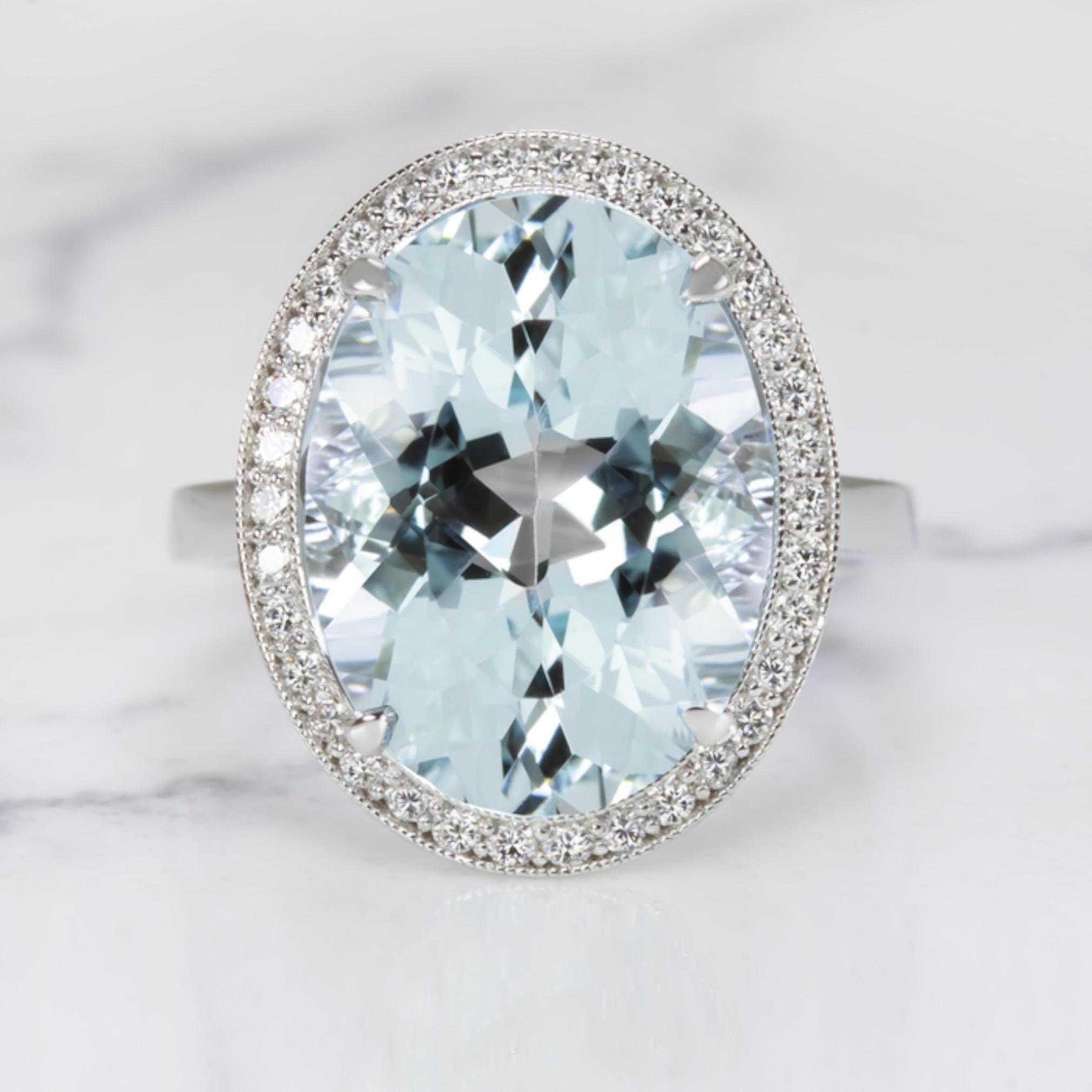 An incredible 8.81 carat natural aquamarine surrounded by a halo of glittering accent diamonds. With its substantial size and gorgeous sky blue hue, the aquamarine has an absolutely stunning presence! 

The effect is luxurious and truly eye catching
