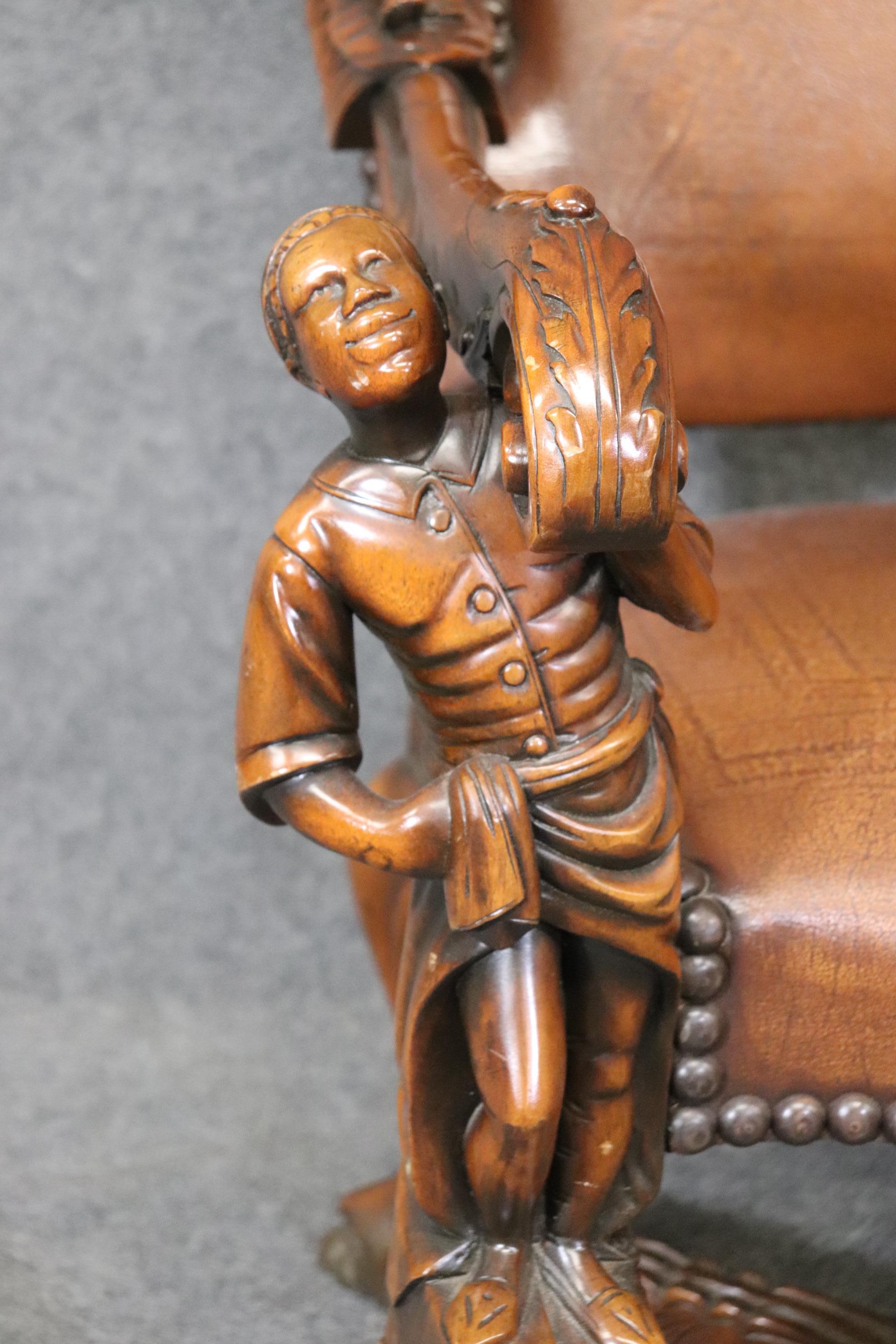 This is a superb replica of an Andrea Brustolon 1700s era figural chair. The chair has gorgeous embossed leather and fantastic carved figures. The chair is very large and rather heavy. The chair measures 45.25 tall x 31 wide x 31 deep x seat height