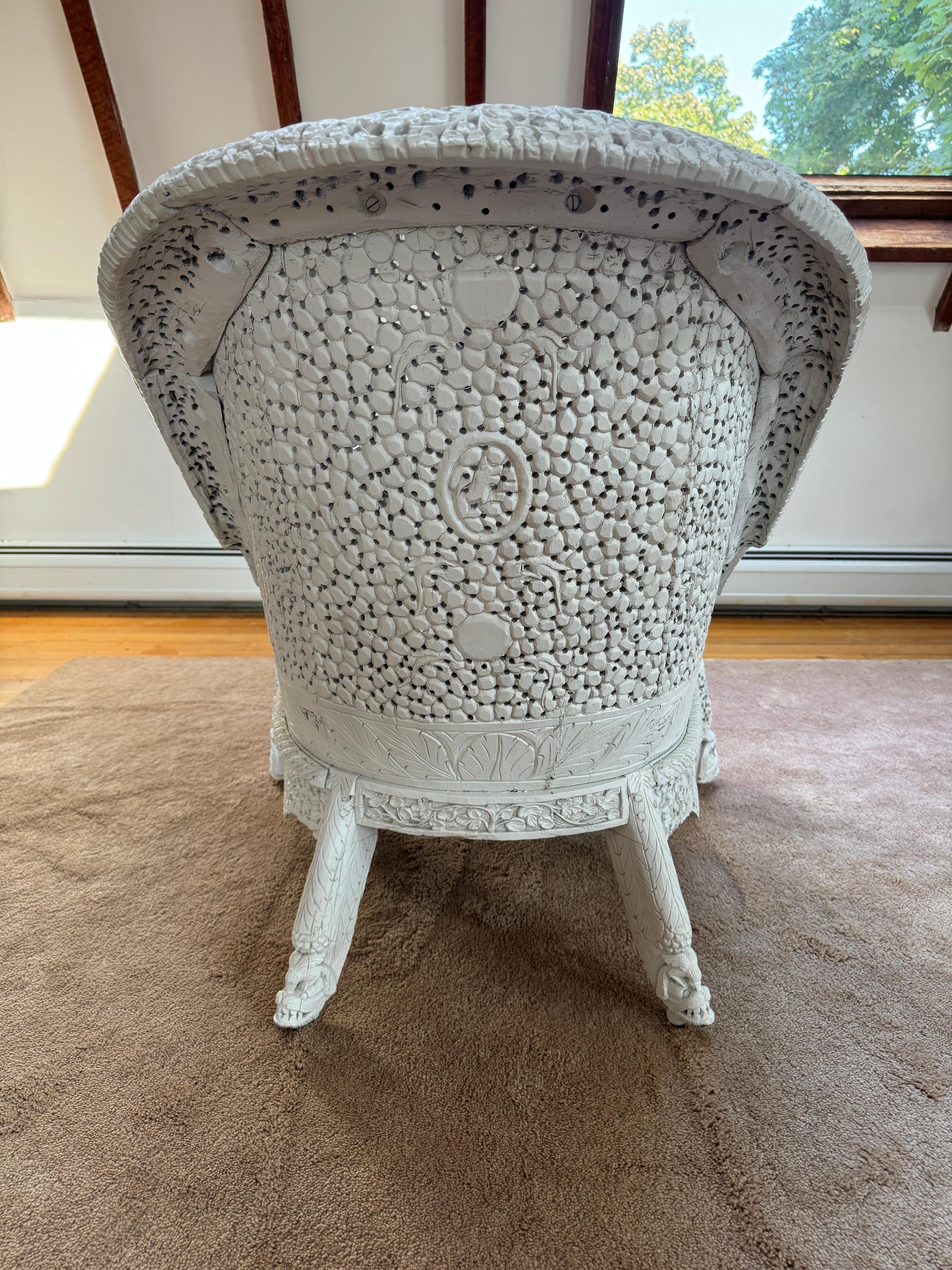 Gorgeous meticulously carved detailed Anglo Indian arm chair having white painted teak wood.  The 19th century work of art has intricate details including the crest rail and “Beastie and Boteh” front supports.  An updated chic Lee Jofa Suzani style