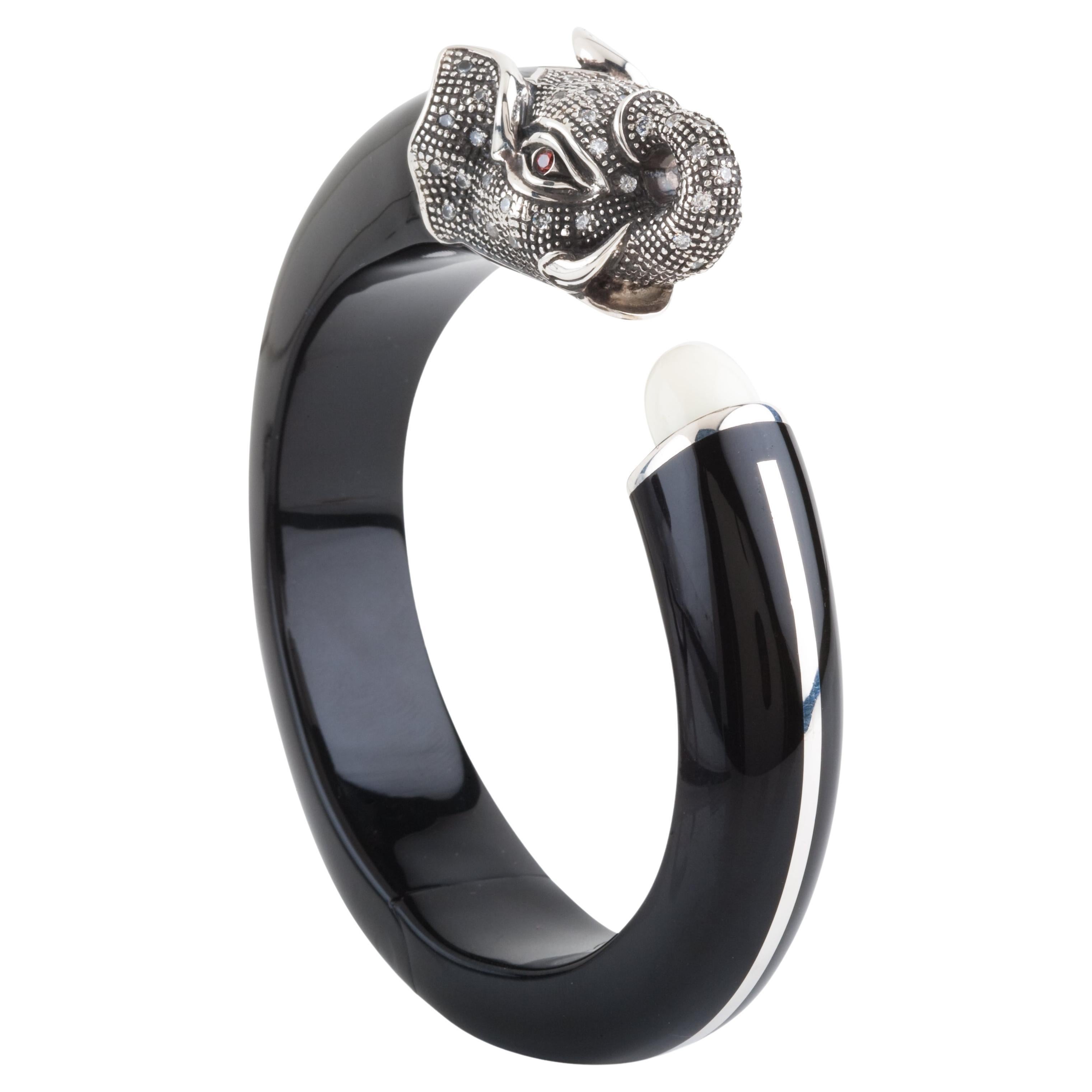 This Miriam Salat bangle features black resin with vintage sterling silver. 
Cubic zircon full diamond facet rounds, prong set.
Bangle is flexible to fit your hand.  With magnetic closure. 
Measures apx. 6-1/2 inches
1.1/2 inches in width. Total