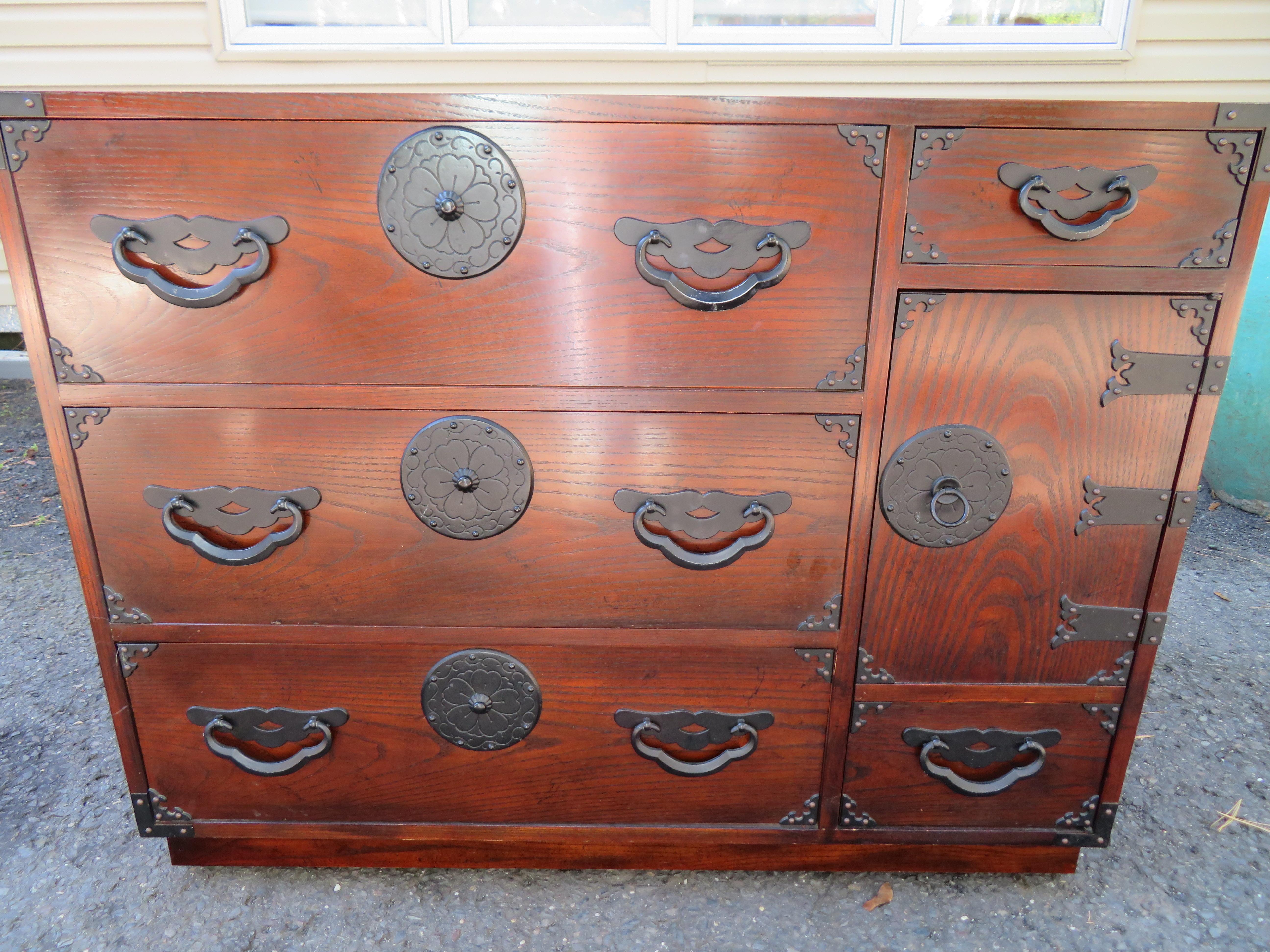 Amazingly beautiful Japanese Tansu bachelors chest by Baker. Dark stained oak with fantastic Japanese inspired hardware. They have a time-worn patina with splendid charm. I love the vintage look of these- gives your interior real Mid-century
