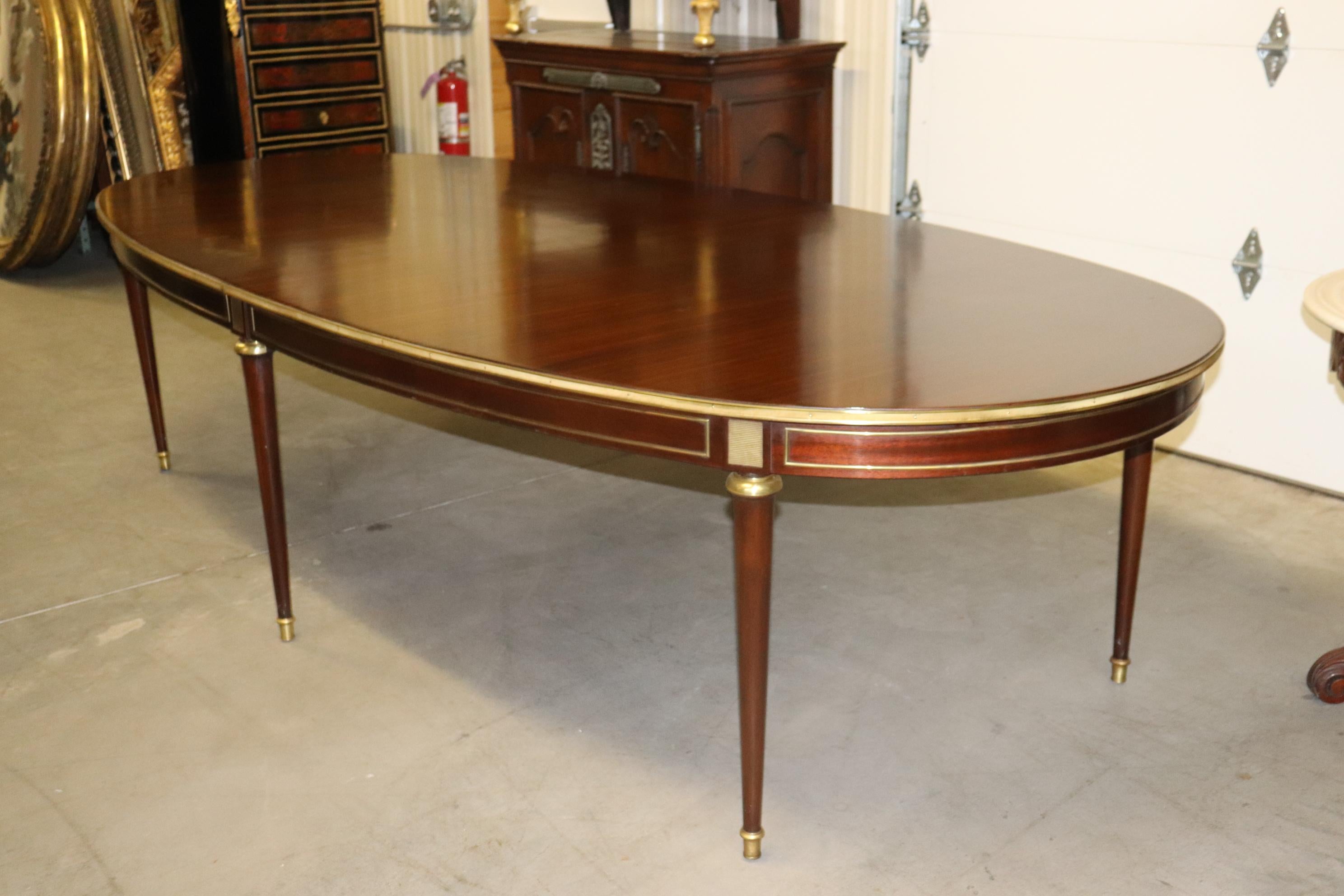 This is a spectcular mahogany and brass mounted conference or dining table. The table is a fixed top and doesn't open or close. The table measures 122 wide x 58 deep x 30.5 tall and has 6 legs and a great original finish on top with minor signs of