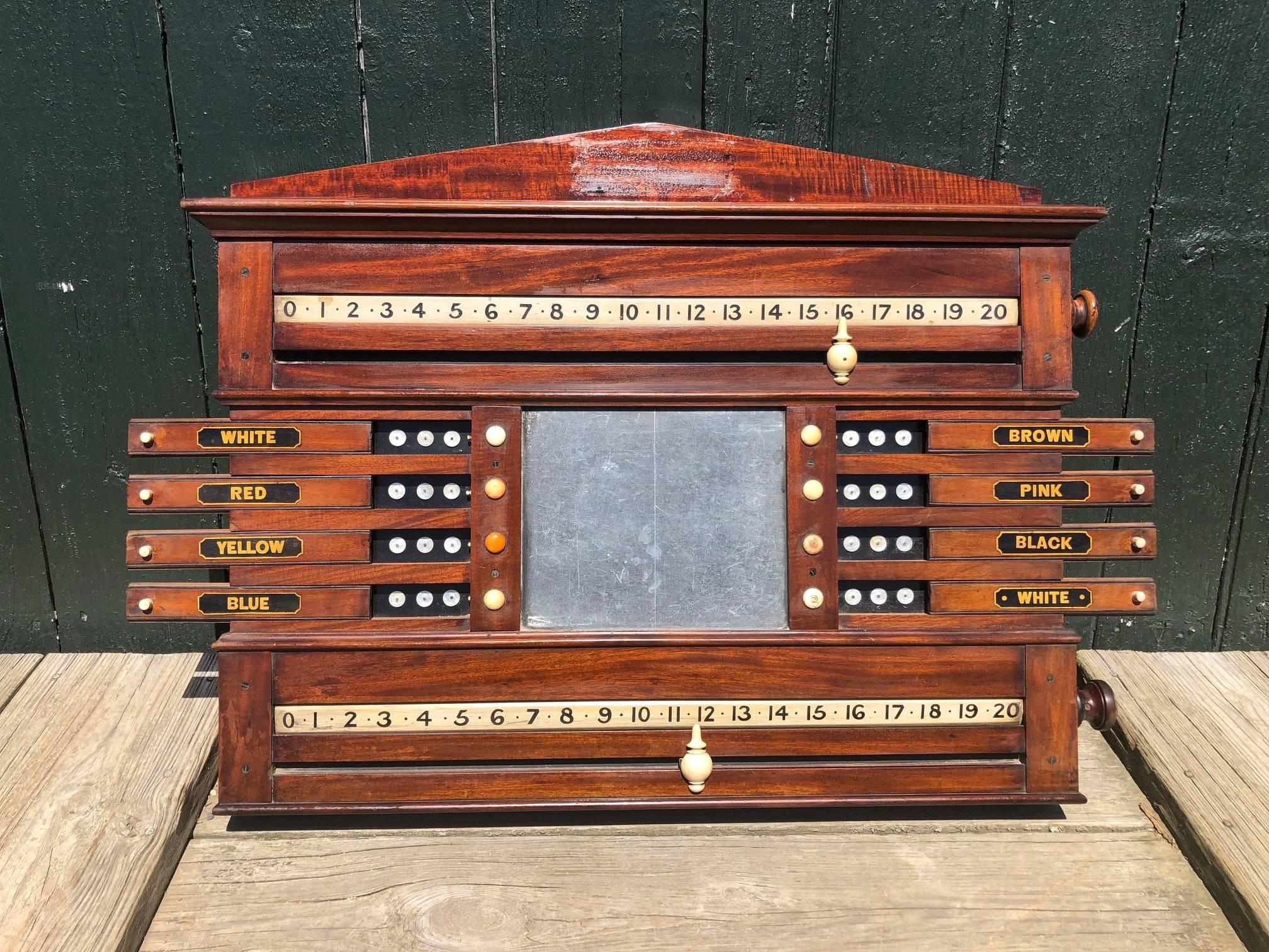This British snooker or billiard scoreboard is made of mahogany and has bone and mother-of-pearl markers. Perfect wall accent for a game room or office. Bought in the North of England, about 100 years old. There are hooks on each side for easy