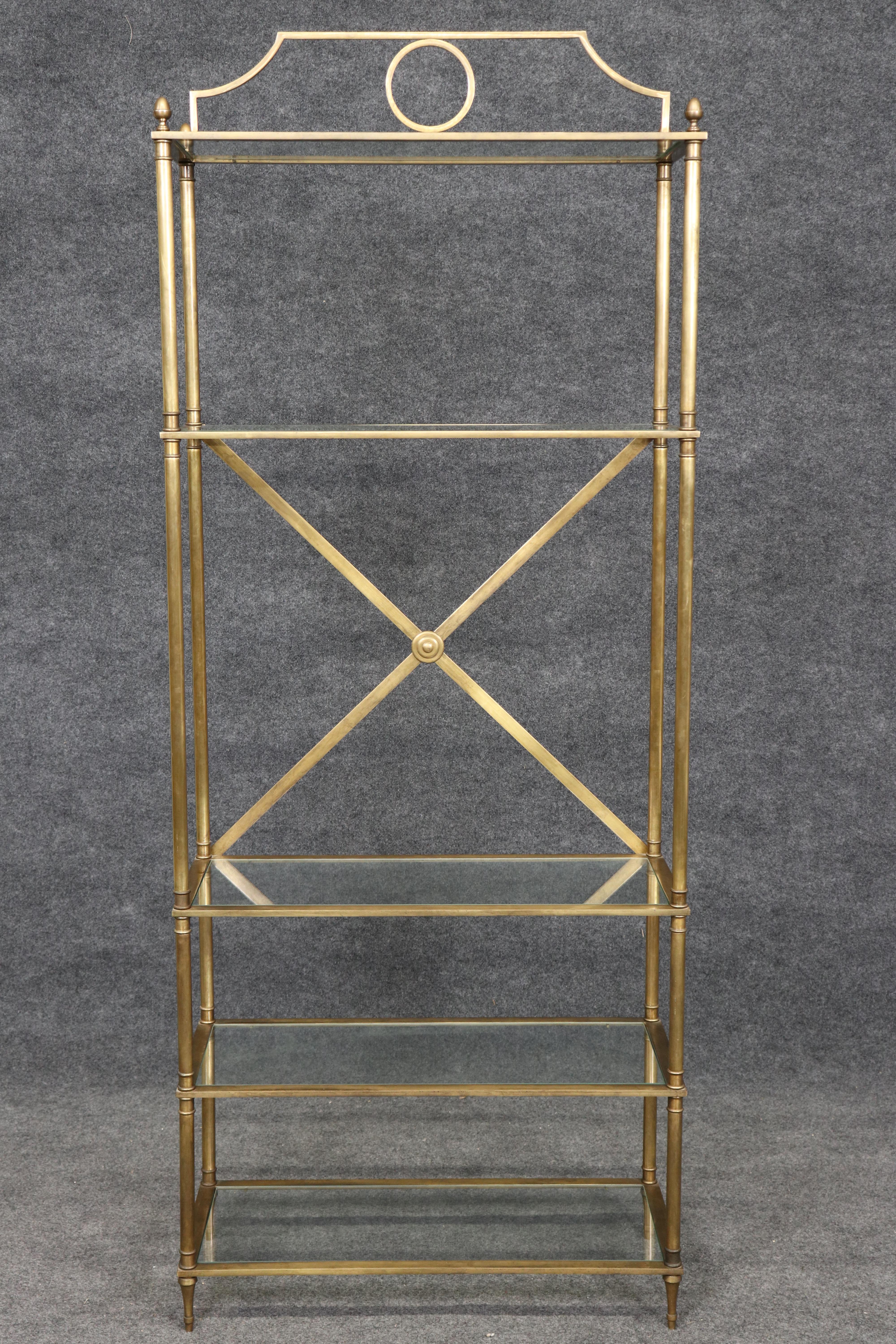 Si tratta di una bellissima e unica etagere in ottone francese in stile Maison Jansen a 5 piani. L'etagere è in buone condizioni, con lievi graffi e una crepa sul bordo di un ripiano in vetro, ma niente di significativo. Il pezzo risale agli anni