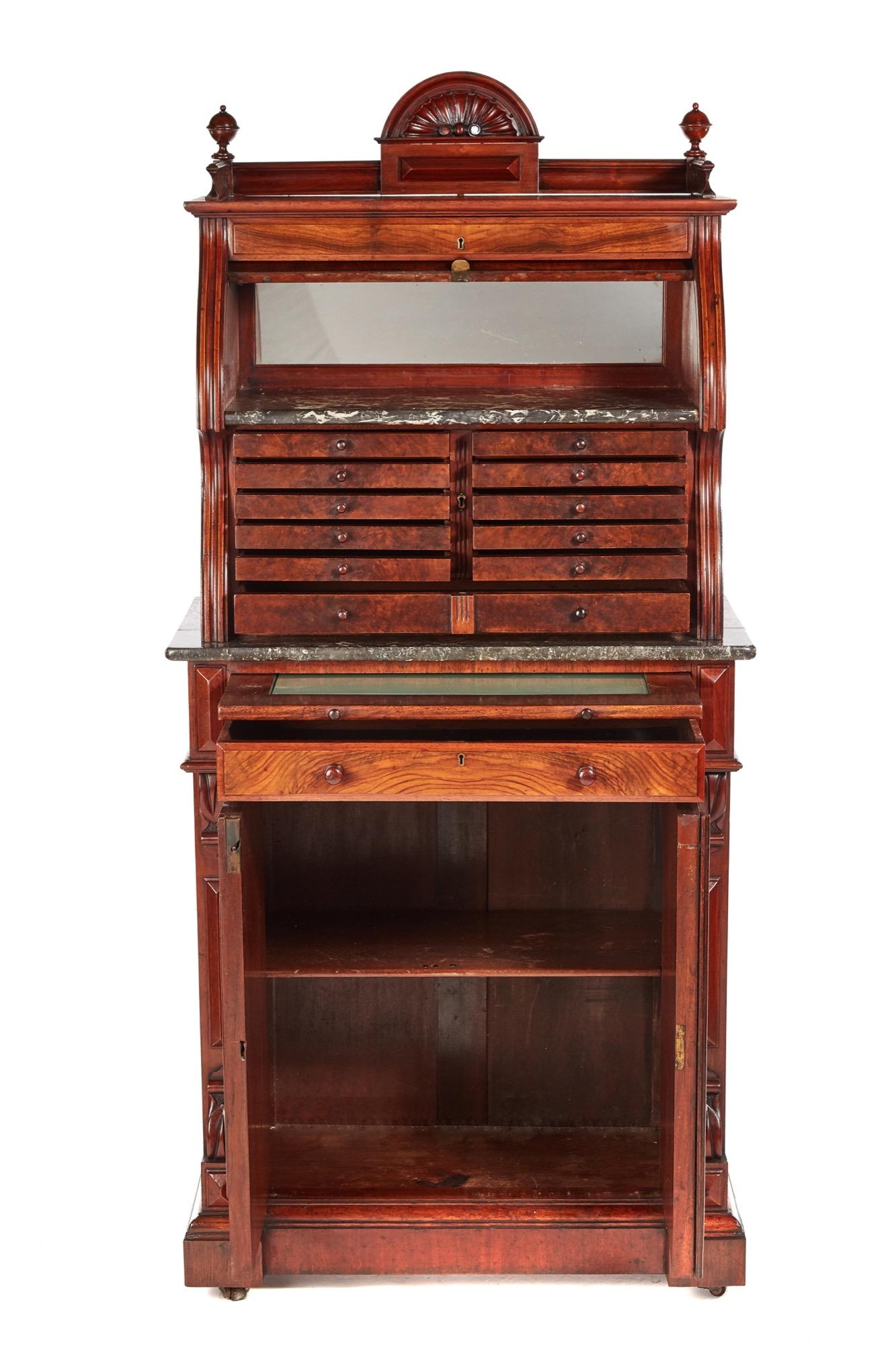 Fantastic burr walnut dentist cabinet with a carved shell top gallery and a burr walnut cylinder that opens to reveal a mirror and grey variegated and speckled marble, 12 graduated burr walnut drawers with original turned walnut knobs. The base with