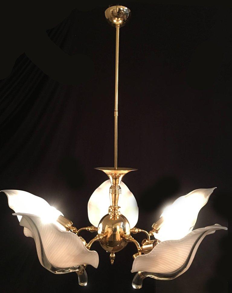 Great and wonderfully precious Murano chandelier in handblown glass leaves and gold-plated hardware by the famous master designer Franco Luce. Also available a pair of sconces.