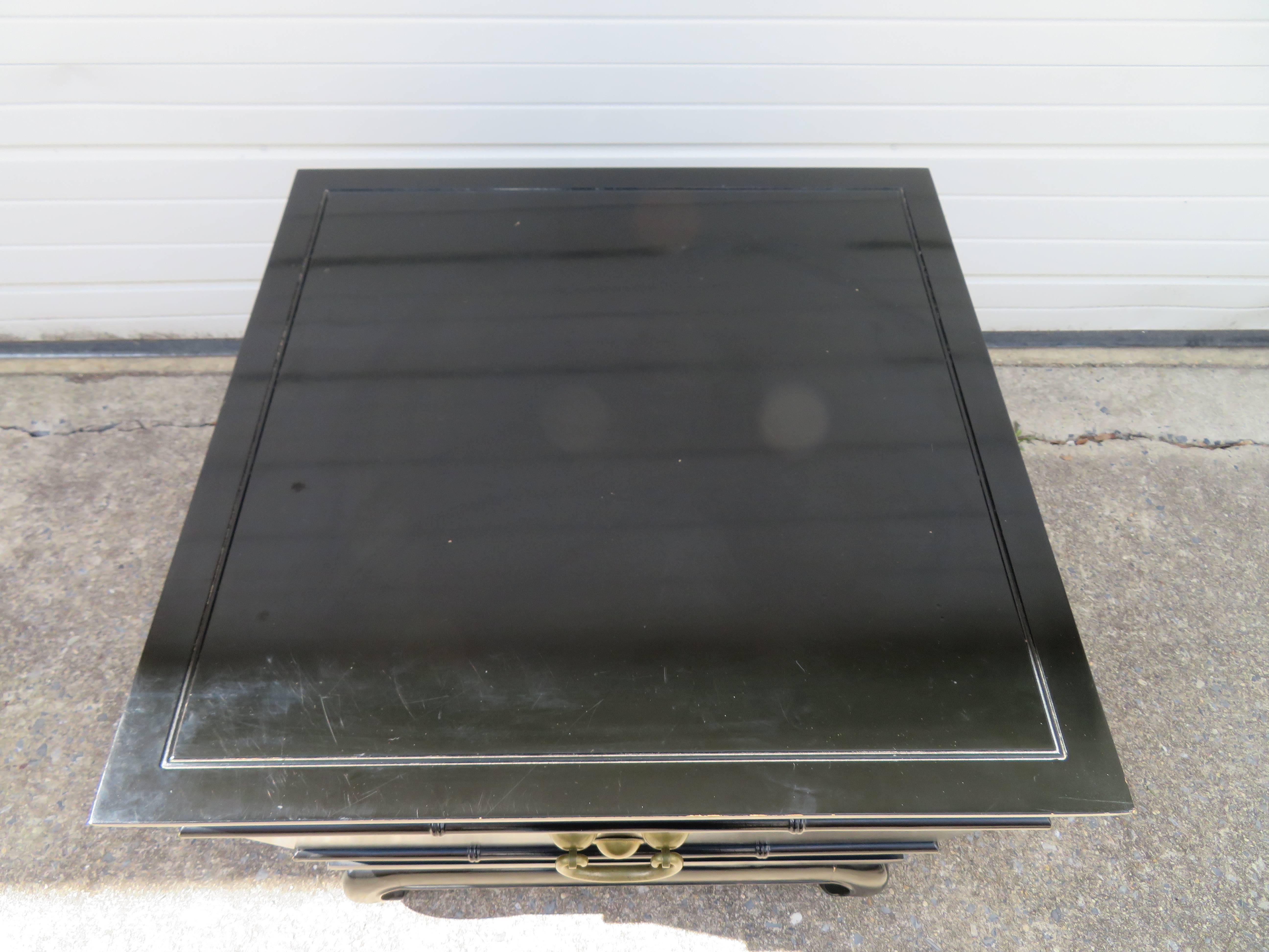 Fantastic chinoiserie style black lacquered Lane end table with hidden pull down door. The nicely concealed door flips down revealing a black formica desktop-great space to set some snacks or drinks and inside an open space for magazines. We love