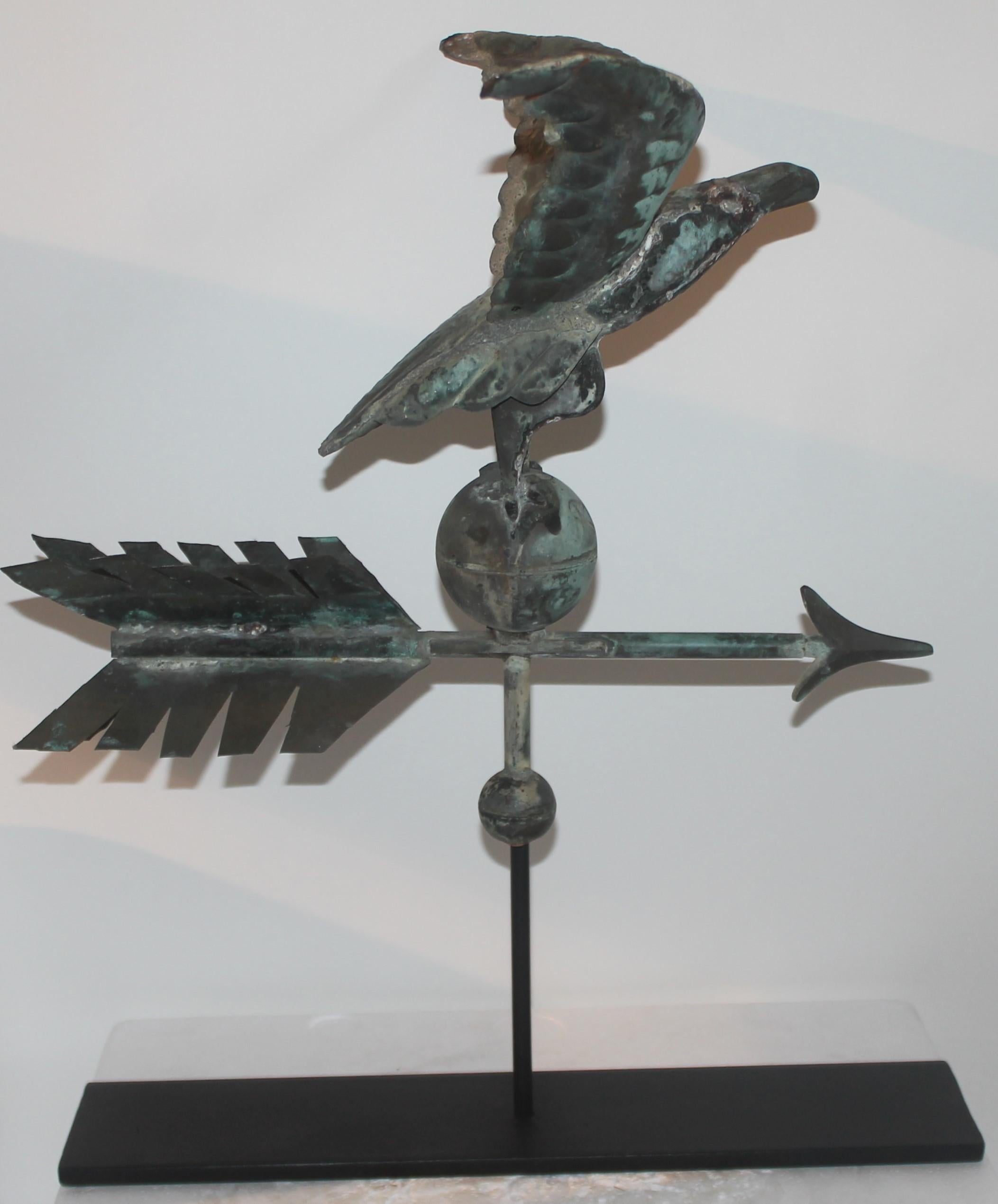 This amazing small-scale rare 19th century eagle weather vane sits on top of the unusual arrow in a verdigris copper patina. The nose is in zinc and so is the tip of the arrow. This vane sits on a custom-made iron stand. Great addition to any Folk