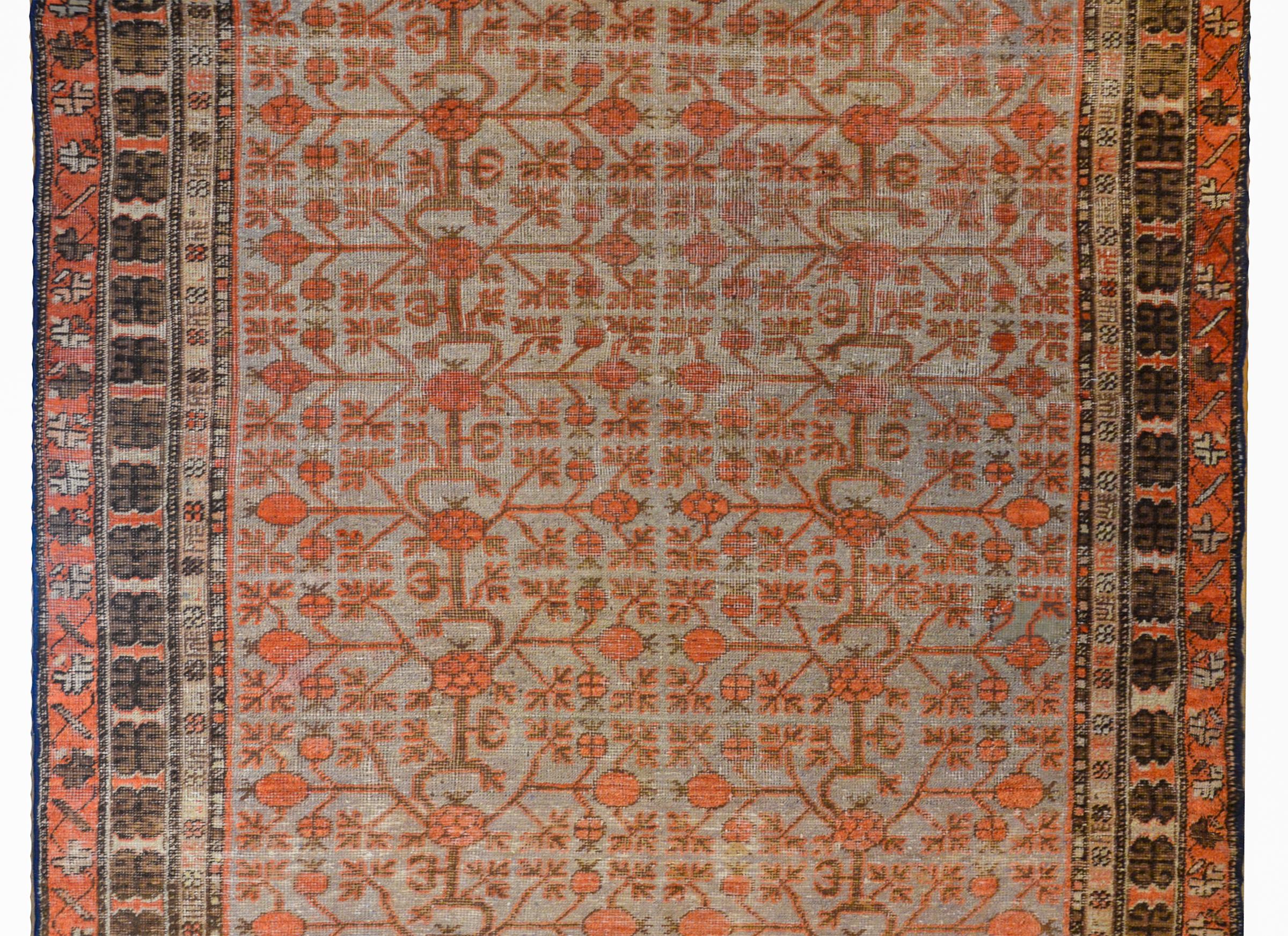 Fantástica alfombra Samaghand de principios del siglo XX, de Asia Central, con un motivo de granadas enrejadas tejidas en coral y marrón sobre un campo de añil claro rodeado de un complejo borde con varias franjas florales pequeñas y grandes.
