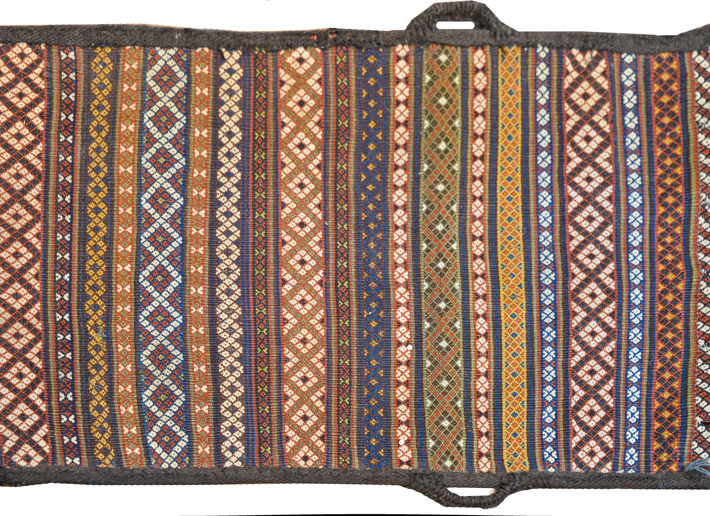 A fantastic early 20th century Persian Shahsevan bag face rug with an intricately woven pattern with multicolored stripes each woven with a geometric lattice pattern. The loops on the sides are original and relate to it's use as a saddle bag.