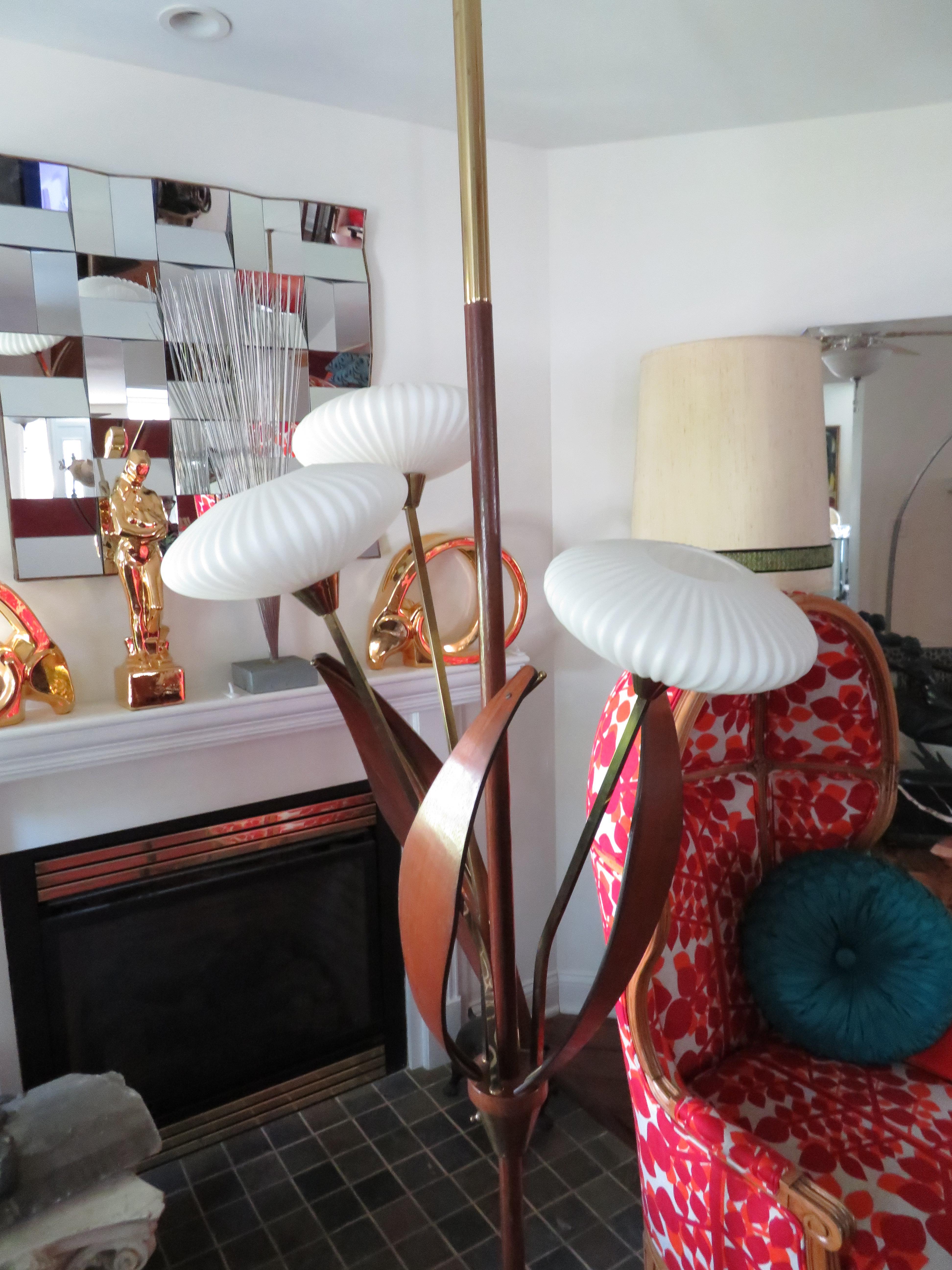 Fantastic brass, walnut and glass flying saucer style tension pole lamp. This piece is in very nice vintage condition with all the original ribbed globes-only some minor wear to the pole. Its three lamps can be lit in sequence, one, two or all