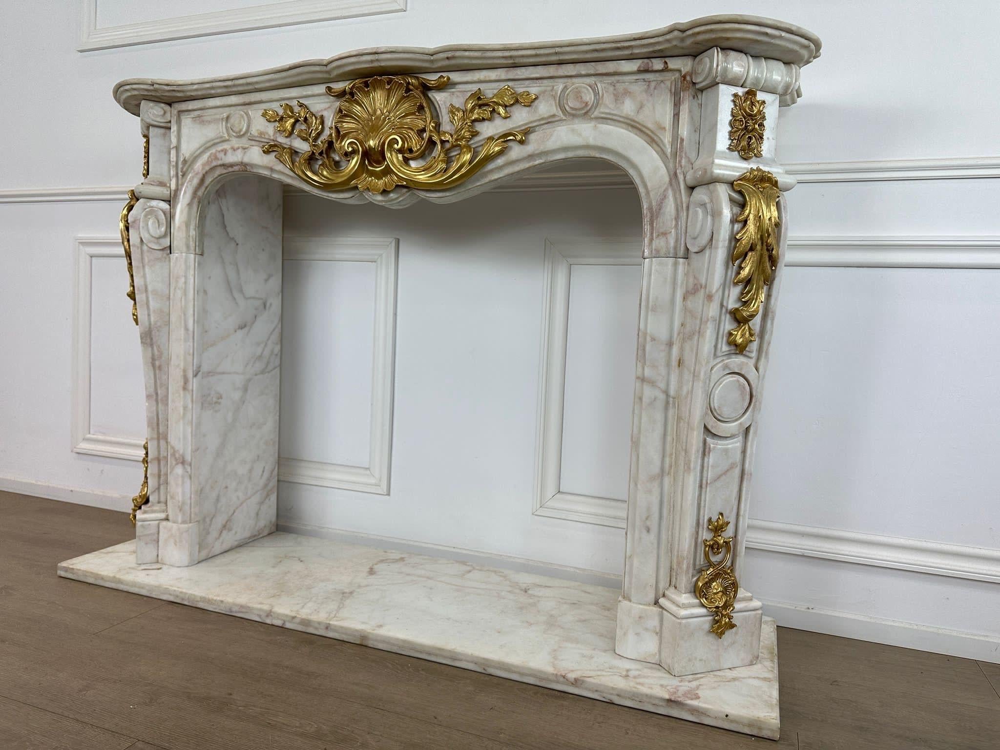 Elevate your living space with a touch of French elegance with a stunning French marble Rococo fireplace. This exquisite piece is a true statement of luxury and sophistication, adding a touch of timeless beauty to any room.

Crafted with intricate