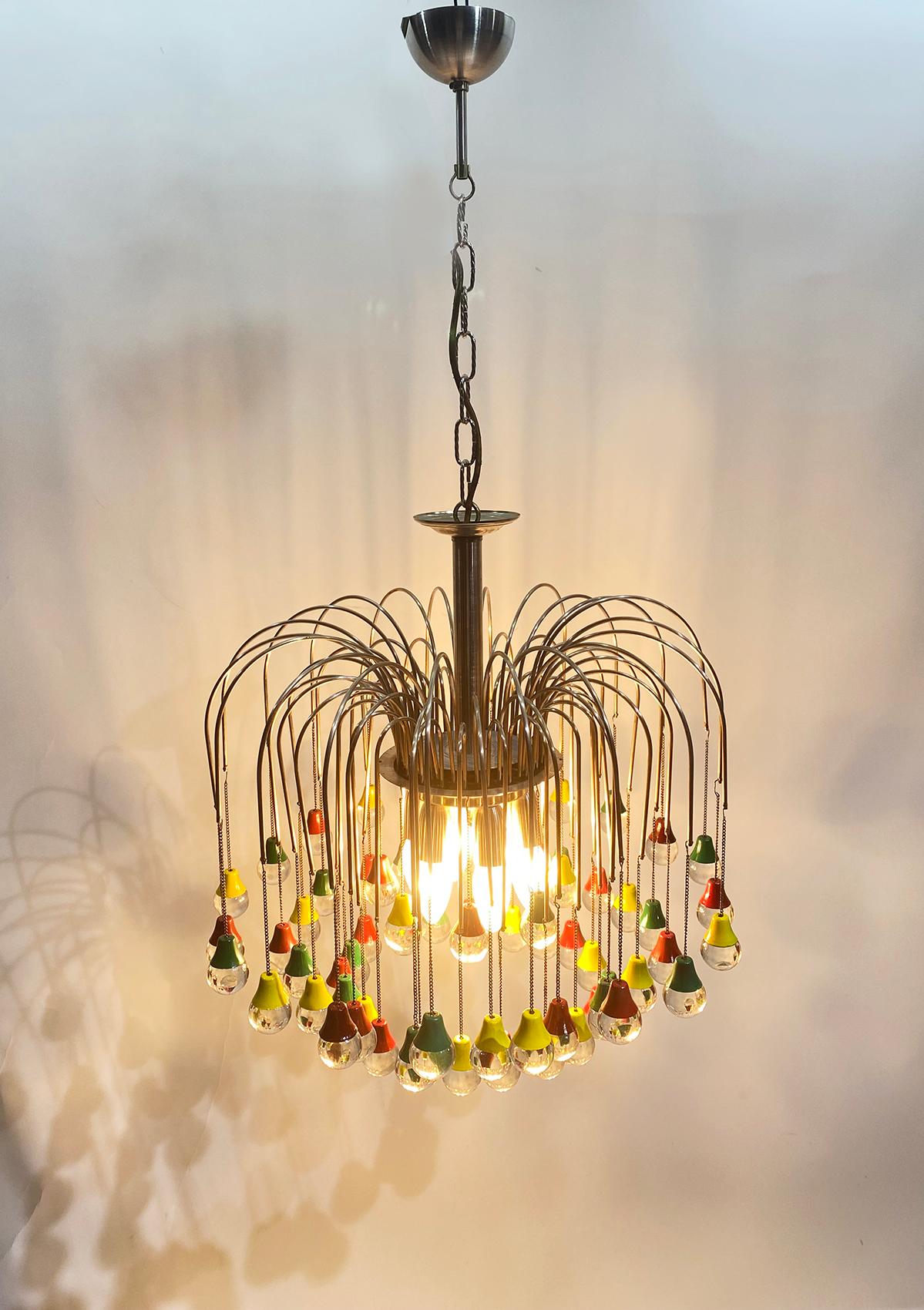 Magnificent teardrop-shaped chandelier made in France in the 1950s.
The Teardrop are held by colored caps in green, red and yellow, with a silver plated structure
The crystal teardrop refracts light in a beautiful way. It fills the room with a