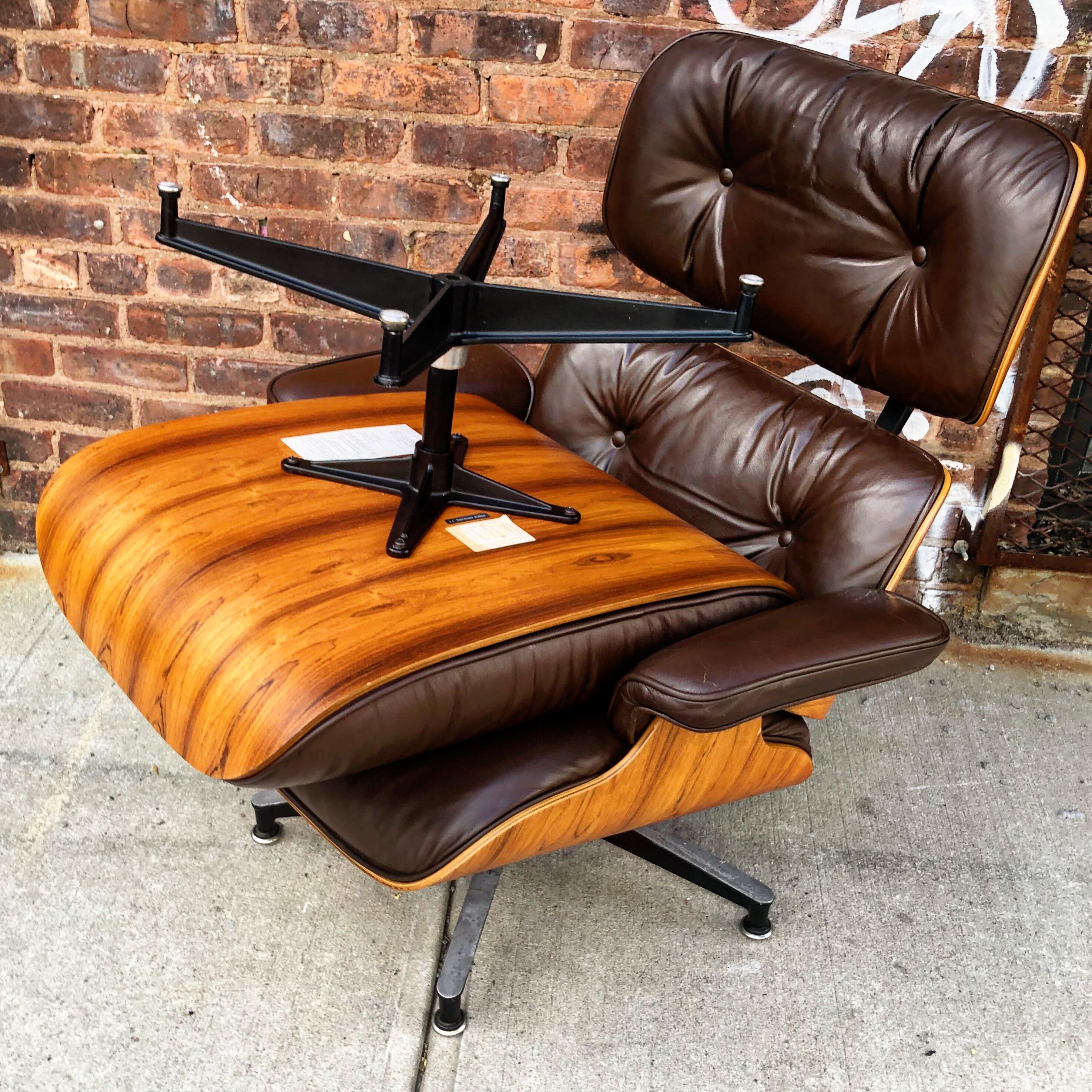 Superb example of the iconic Herman Miller Eames Lounge chair and ottoman. Original brown leather cushions and gorgeous wood color and grain detail. Signed 1970s edition with manufacturer label and patent label.